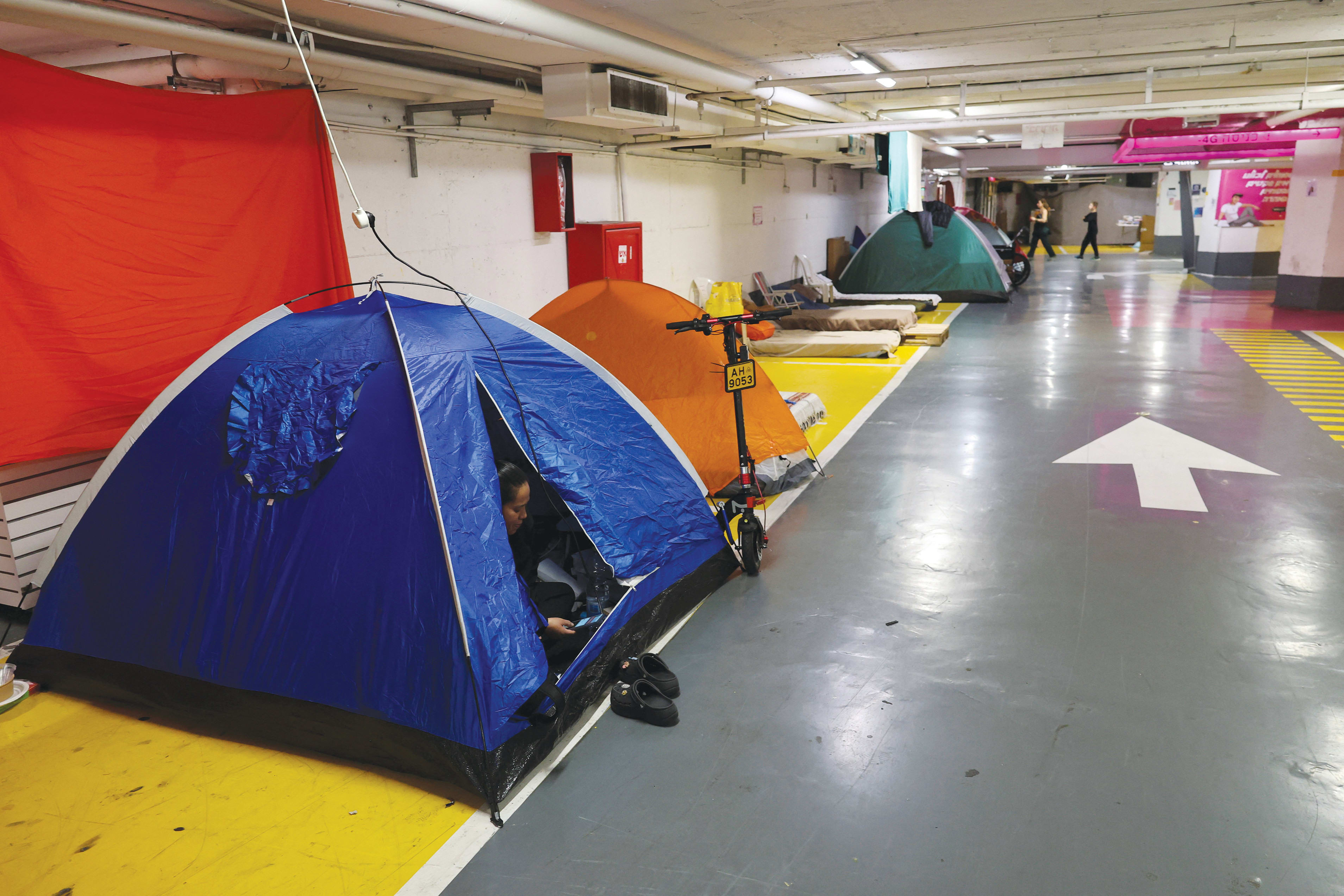 TENTS ARE set in an underground parking garage used as a public bomb shelter in Tel Aviv last month. (photo credit: AMMAR AWAD/REUTERS)