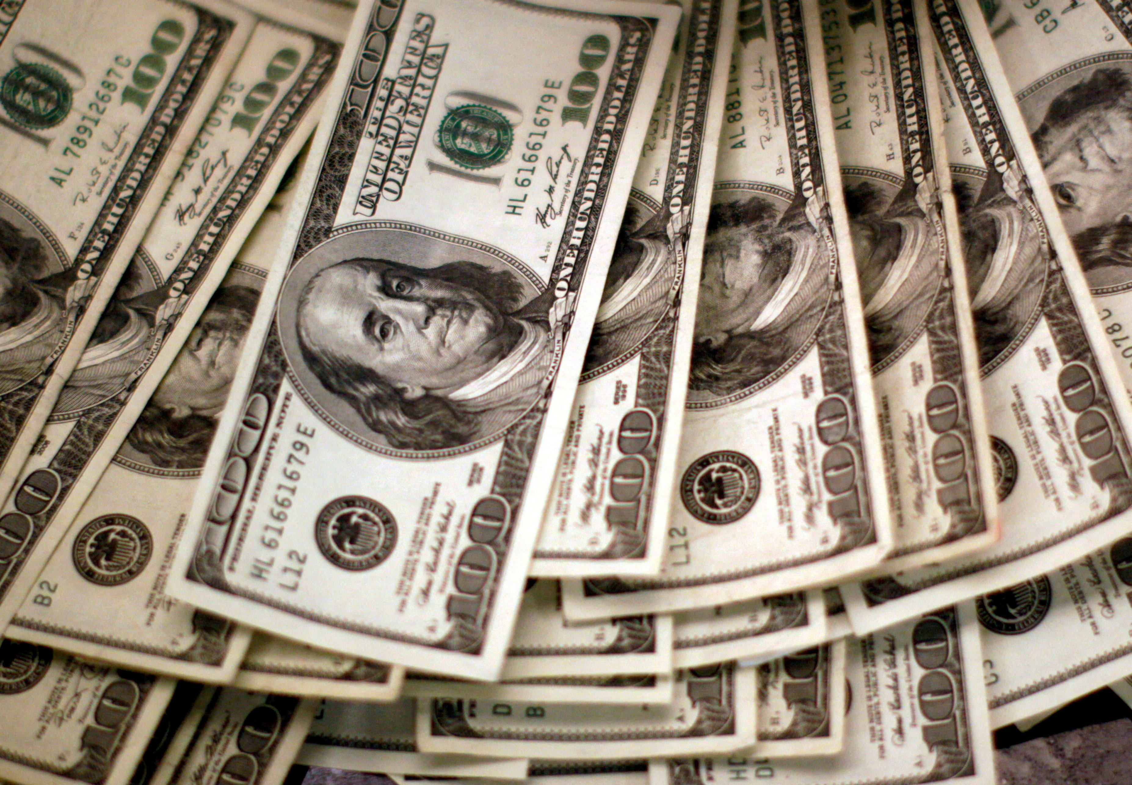  (ILLUSTRATIVE) Four thousand US dollars are counted out by a banker counting currency at a bank in Westminster, Colorado November 3, 2009. (photo credit: REUTERS/Rick Wilking )