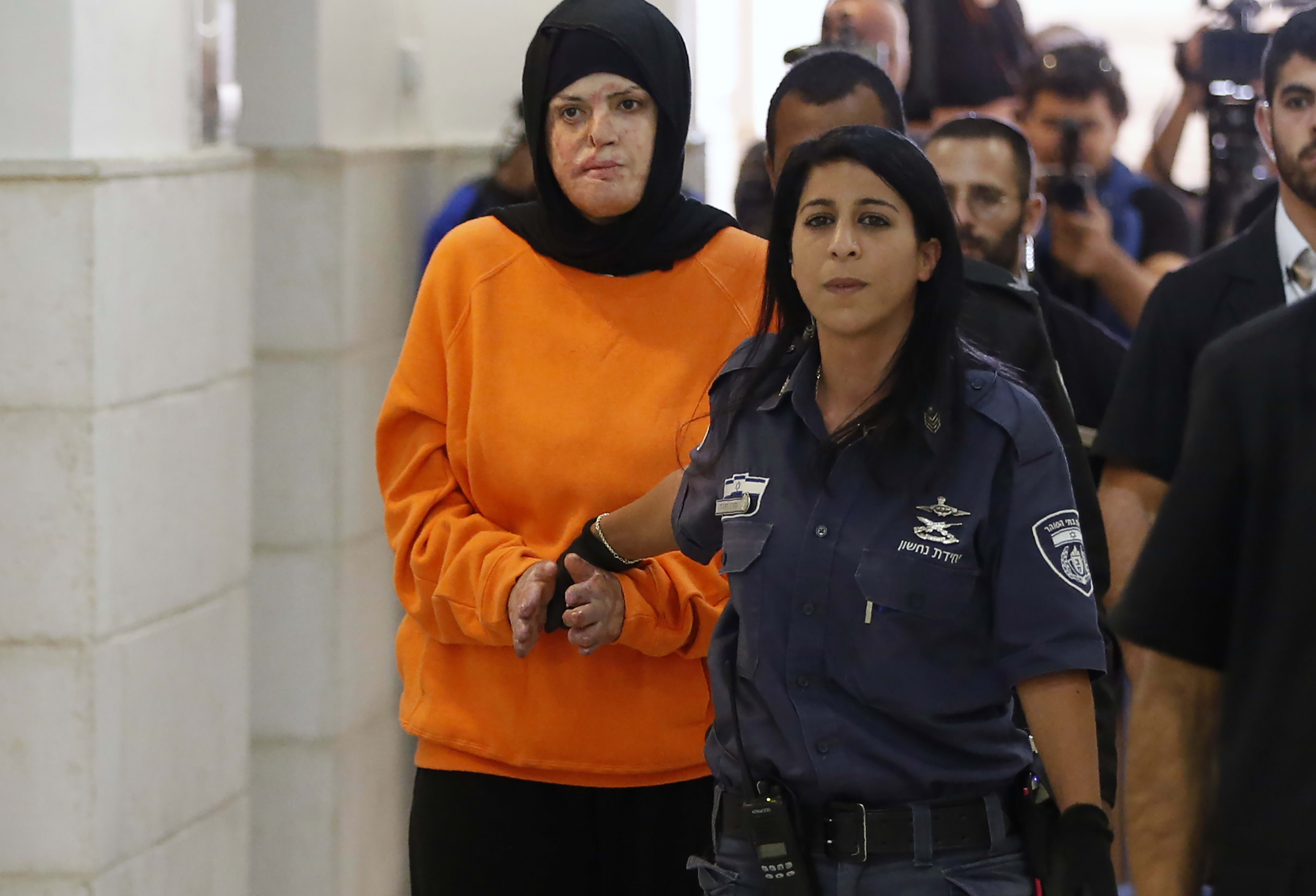 Israa al-Jaabis (L), a 32-year-old Palestinian woman who detonated a small bomb on October 11, 2015 on the highway leading from the Jewish settlement of Maale Adumim to Jerusalem, arrives for her sentencing hearing at the District Court in Jerusalem on November 7, 2016. (photo credit:  AHMAD GHARABLI/AFP VIA GETTY IMAGES)