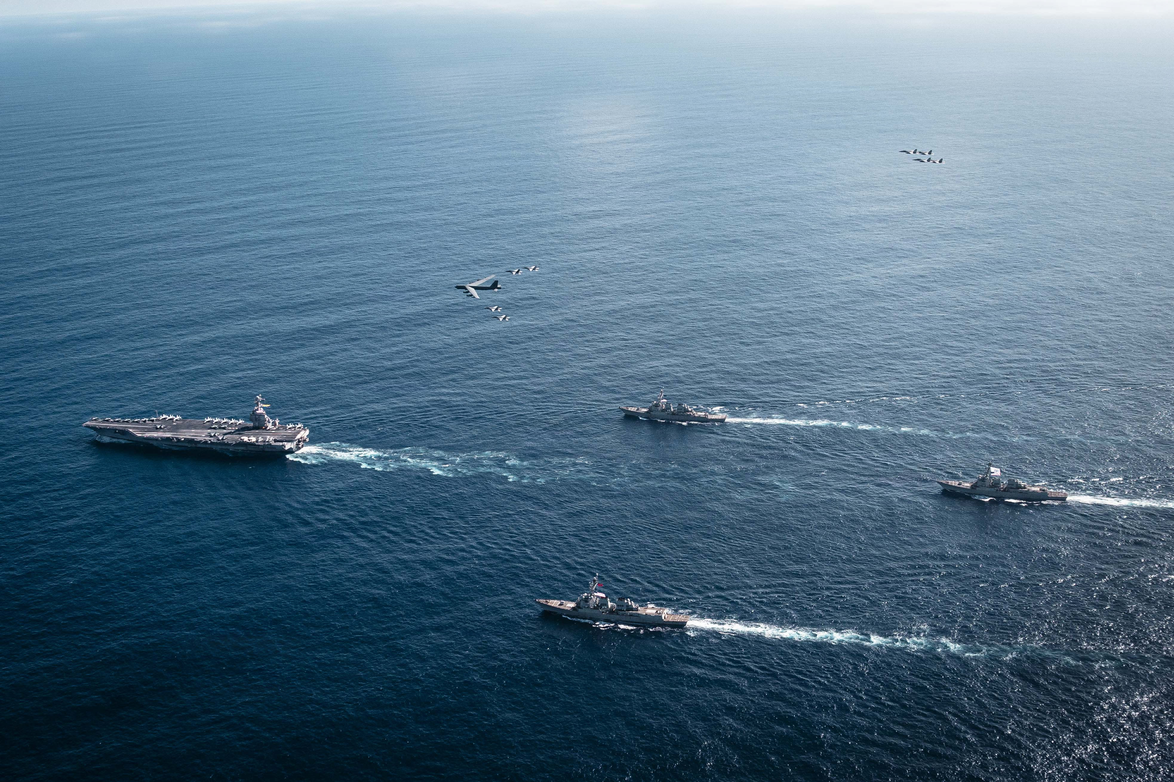 US Navy ships operate as a joint, multi-domain force with a U.S. Air Force B-52 Stratofortress, November 13, 2025.  (photo credit: Tajh Payne/US Navy via Getty Images)