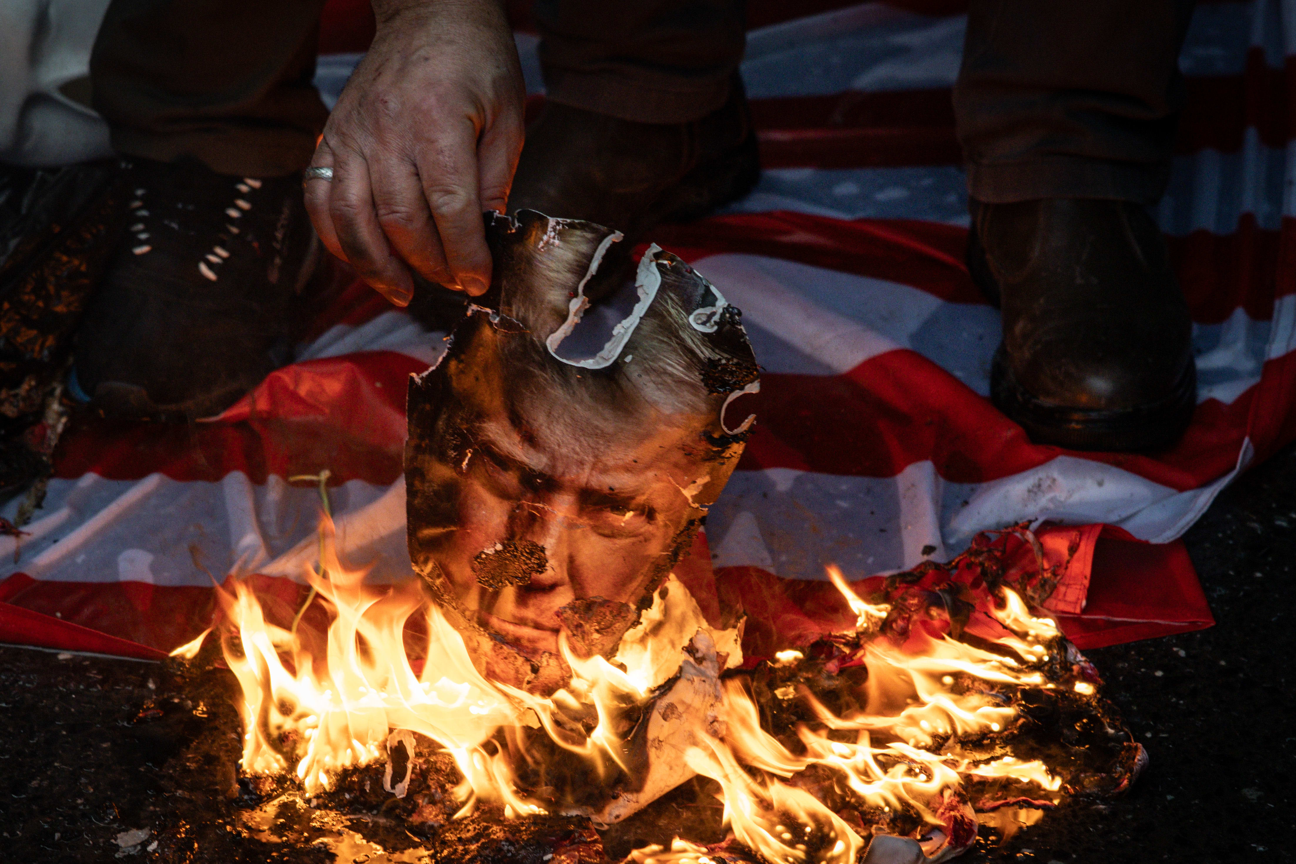 IRANIAN PRO-GOVERNMENT supporters burn pictures of US President Donald Trump, last month. If Trump’s bluster against Iran just leads to another soft deal that kicks the Iranian nuclear can down the road, then Trump’s presidency is finished, the writer says.  (photo credit: Chris McGrath/Getty Images)