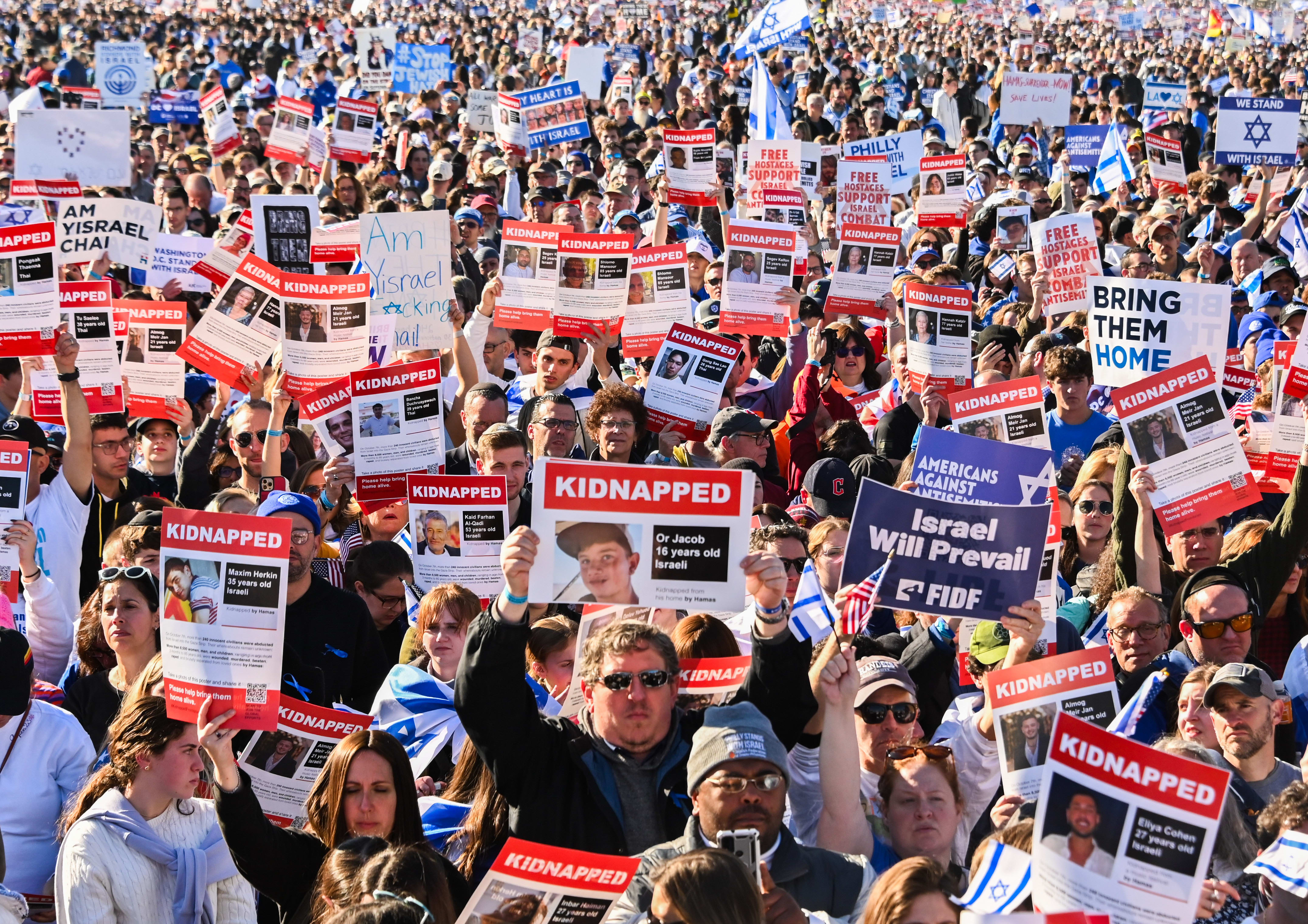 Participants hold up posters of hostages as thousands of people attend the March for Israel on the National Mall in November 2023 in Washington, DC. Following October 7, American Jews mobilized more than $1 billion for Israel’s relief and recovery. (photo credit: Noam Galai/Getty Images)