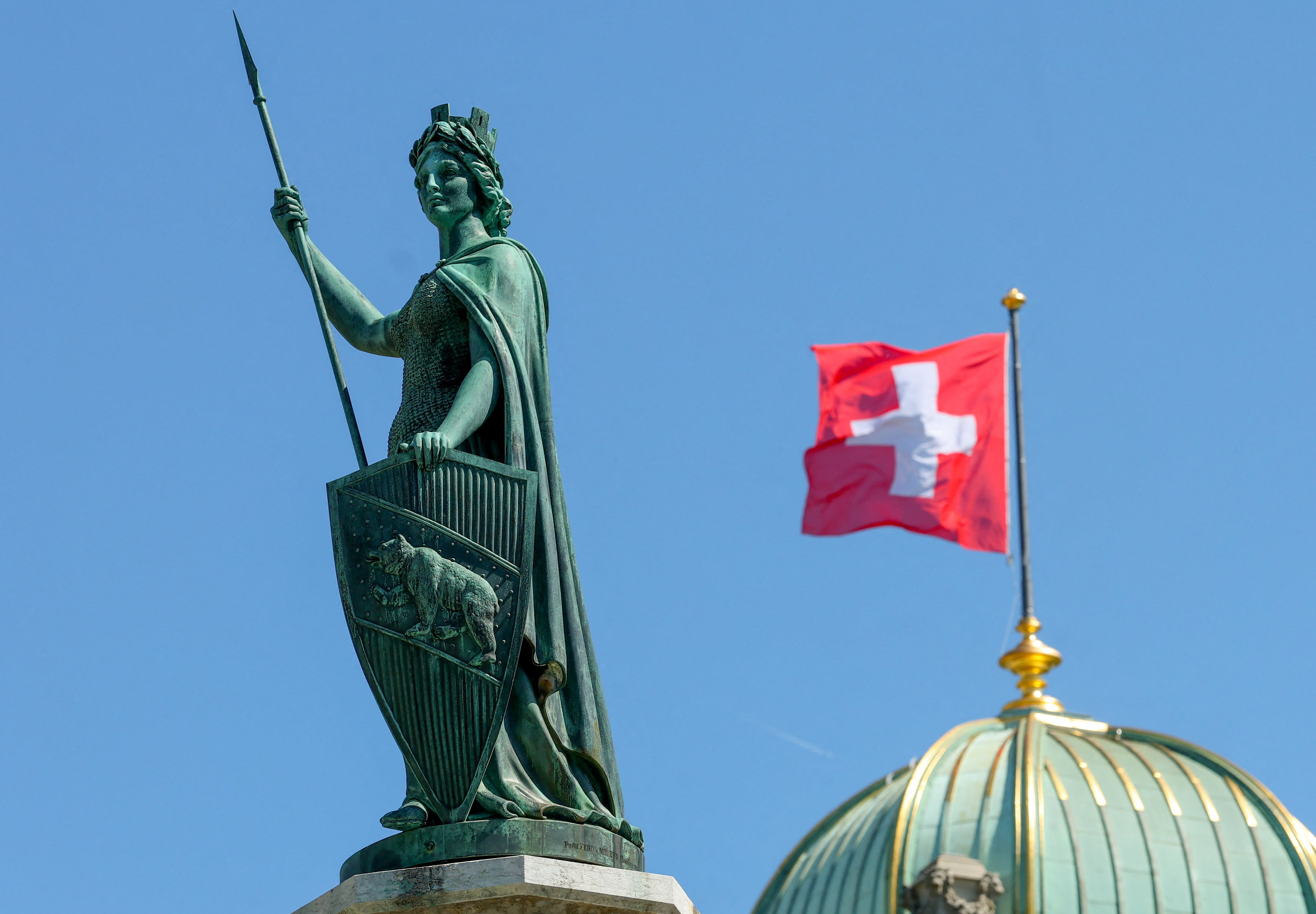 The Helvetia statue in front of a Swiss flag on the Swiss Parliament building (Bundeshaus) ahead of a press conference on Swiss banks