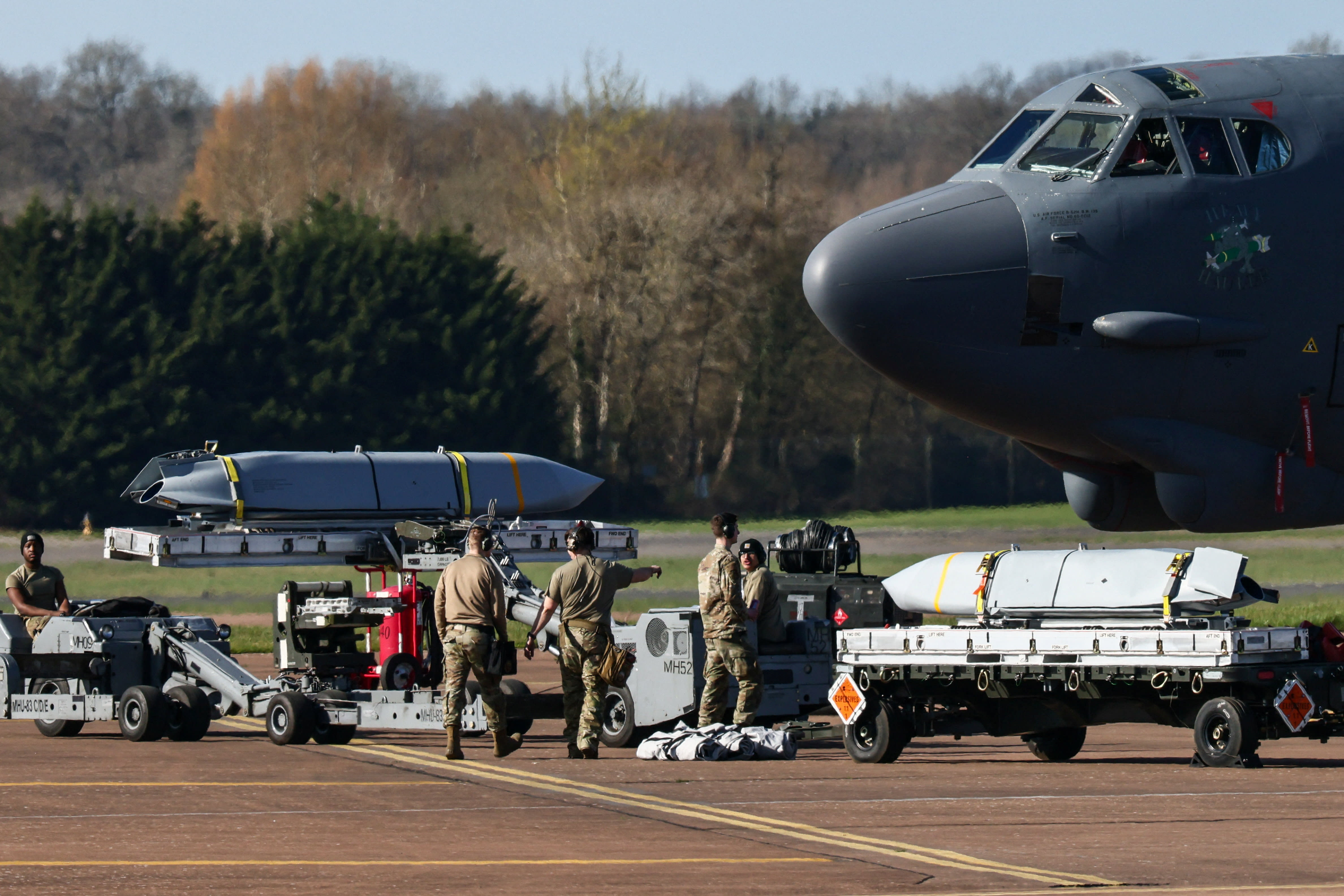 Members of a ground crew work to load cruise missiles into a U.S. Air Force Boeing B-52 Stratofortress at RAF Fairford airbase, used by United States Air Force (USAF) personnel, amid the U.S.–Israeli conflict with Iran, in Fairford, Gloucestershire, Britain, March 14, 2026. (photo credit: Jack Taylor/Reuters)