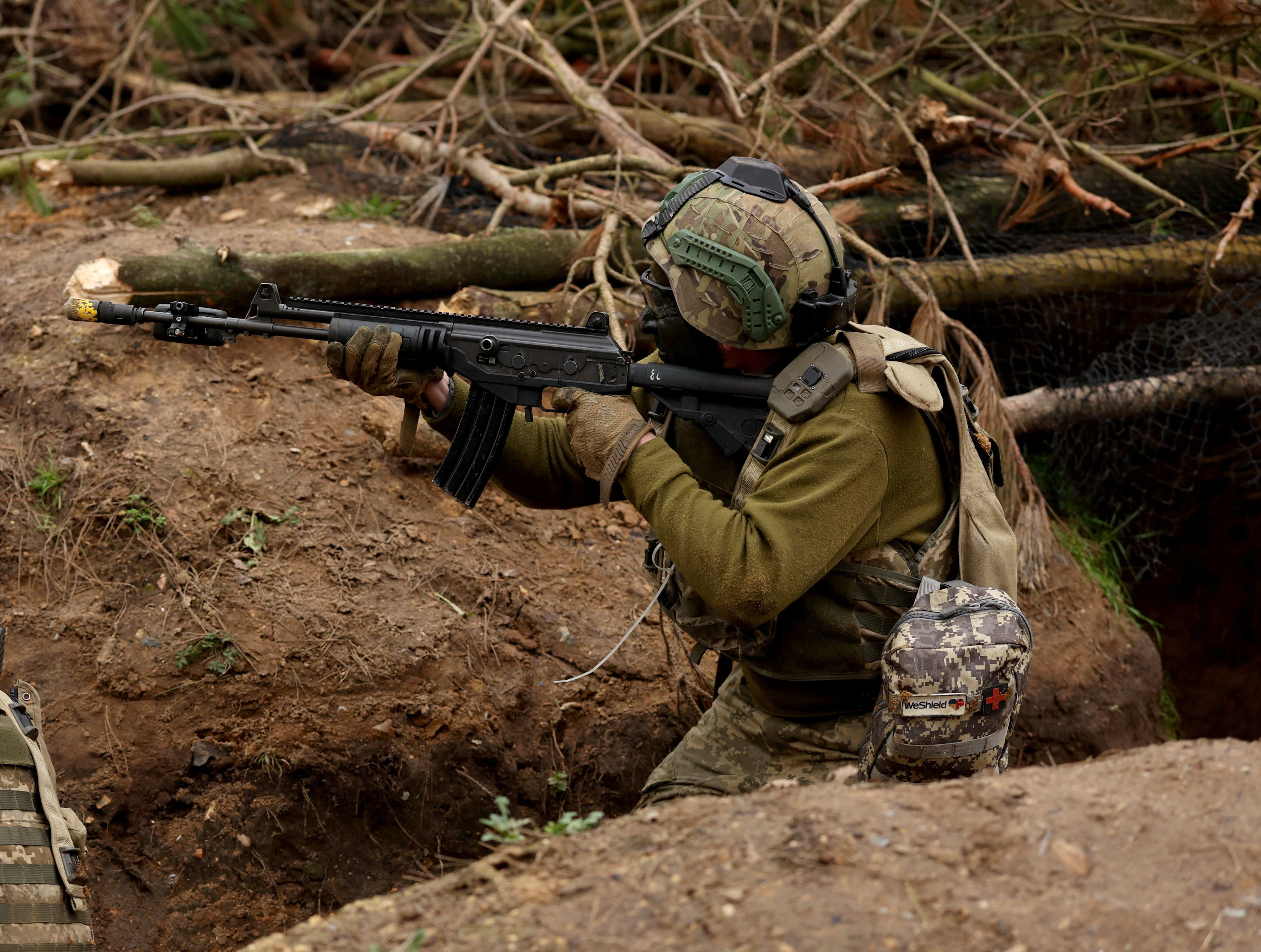 A Ukrainian soldier takes part in a final tactical exercise on the fourth anniversary of Russia