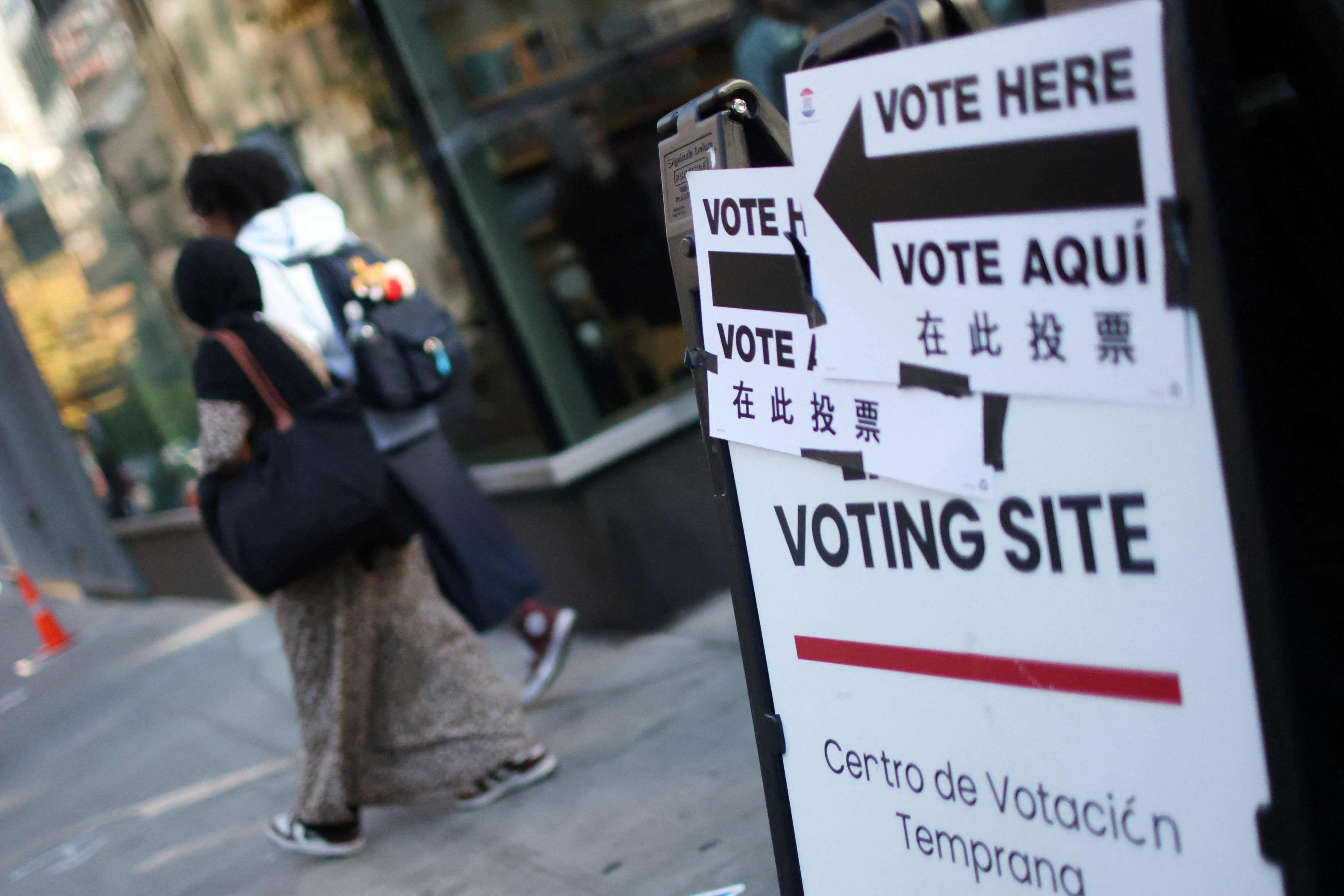 People walk towards a polling site during early voting in the New York City mayoral election in Manhattan in New York City, US, October 27, 2025.  (photo credit: REUTERS/MIKE SEGAR)