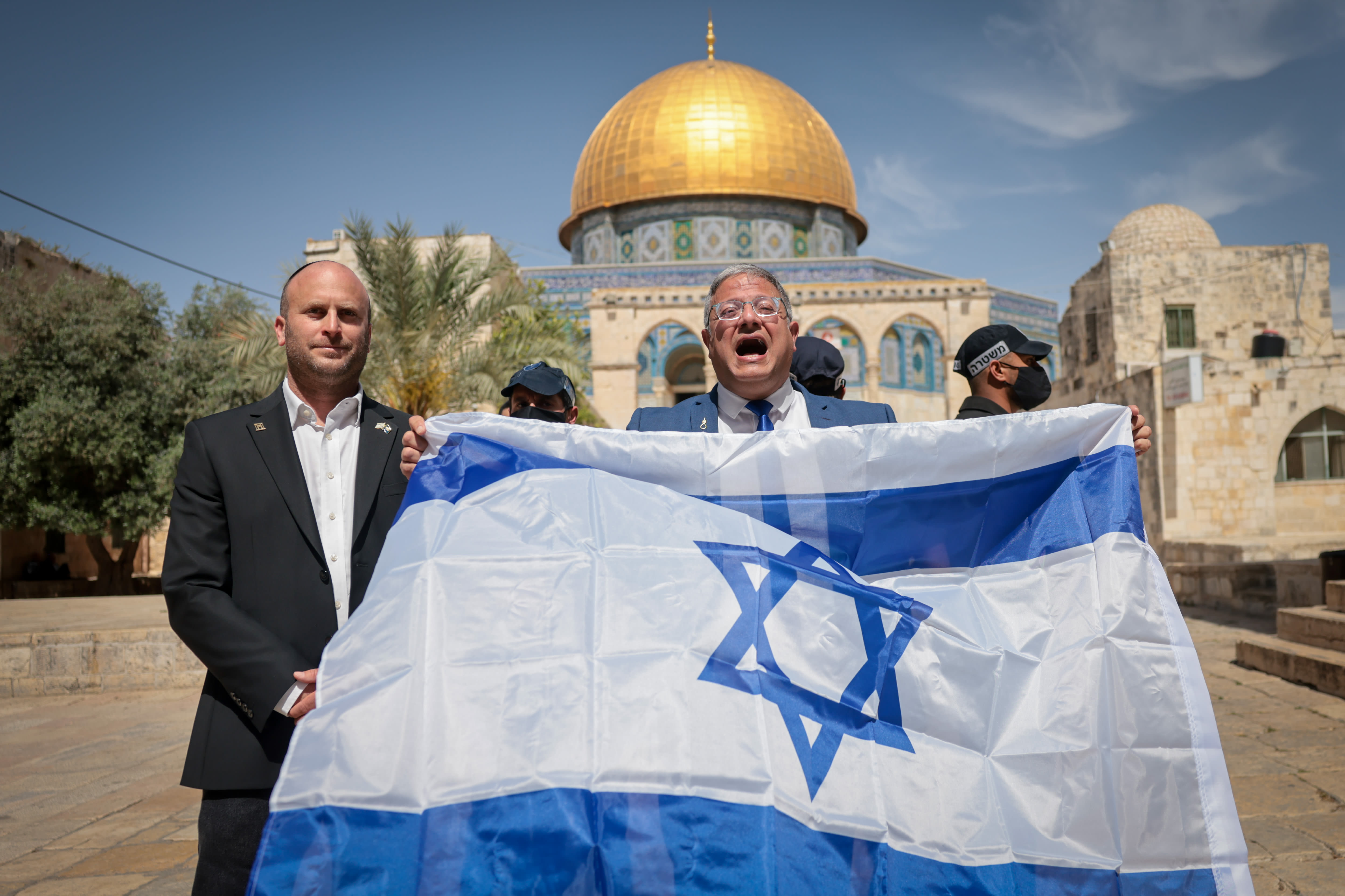 National Security Minister Itamar Ben-Gvir waves the Israeli flag as he tours the Temple Mount in Jerusalem