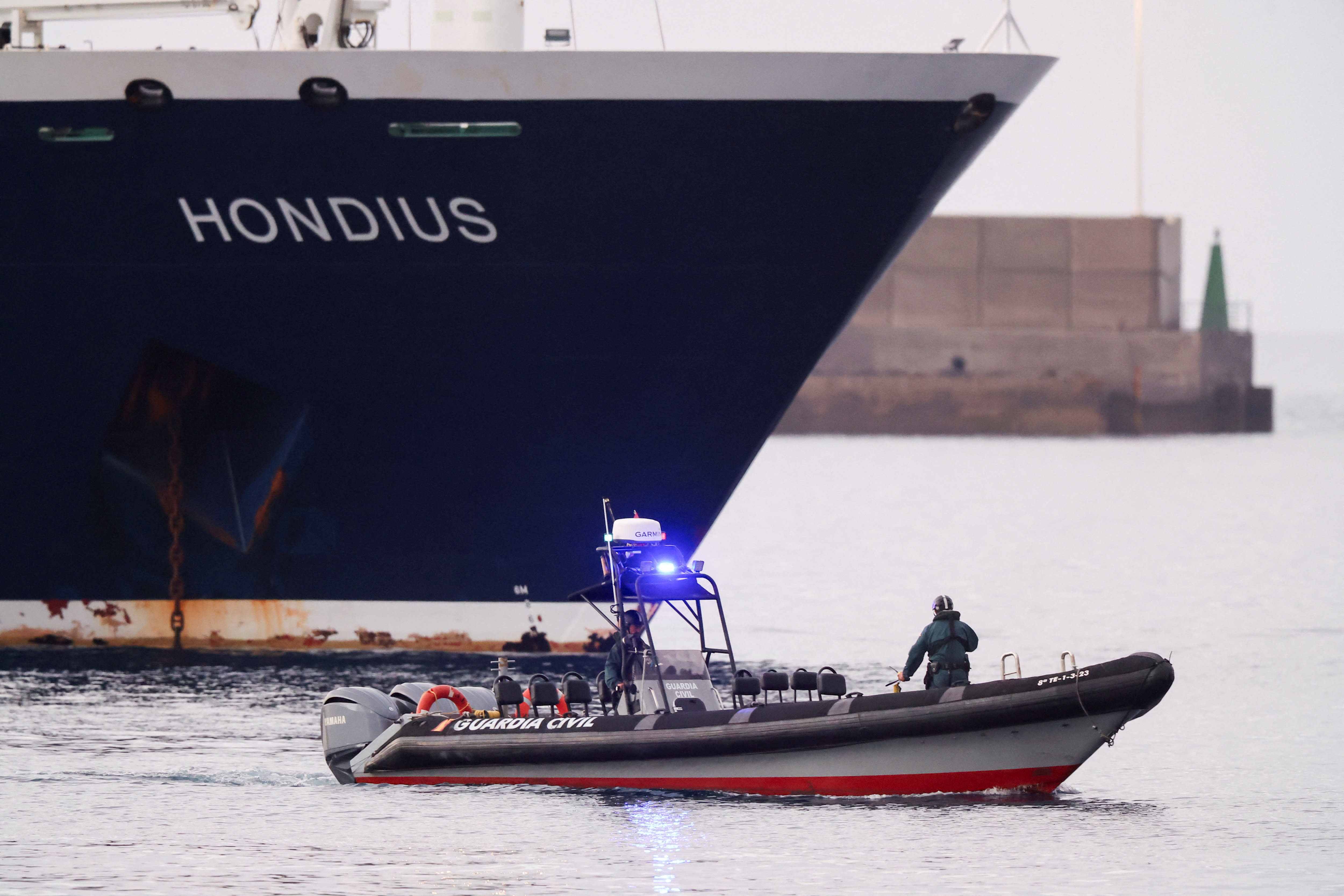 A police boat approaches the cruise ship MV Hondius at the port of Granadilla de Abona after being affected by a hantavirus outbreak, in Tenerife, Spain, May 10, 2026. (photo credit: REUTERS/HANNAH MCKAY)