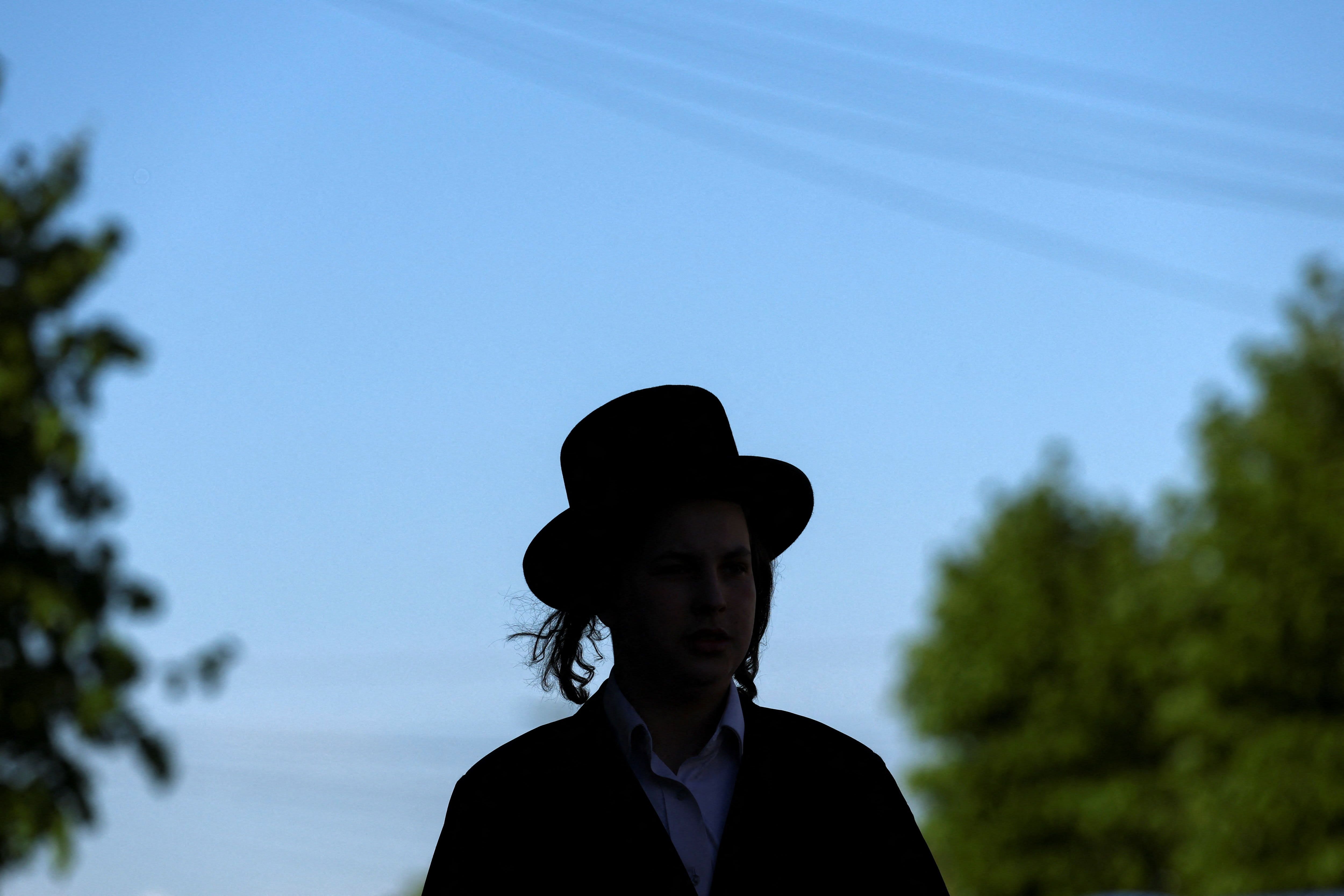 An Orthodox Jew walks near the scene where a man was arrested on Wednesday following a stabbing incident in which two Jewish men were wounded in the Golders Green area, which is home to a large Jewish population, in London, Britain, April 30, 2026.  (photo credit: REUTERS/HANNAH MCKAY)