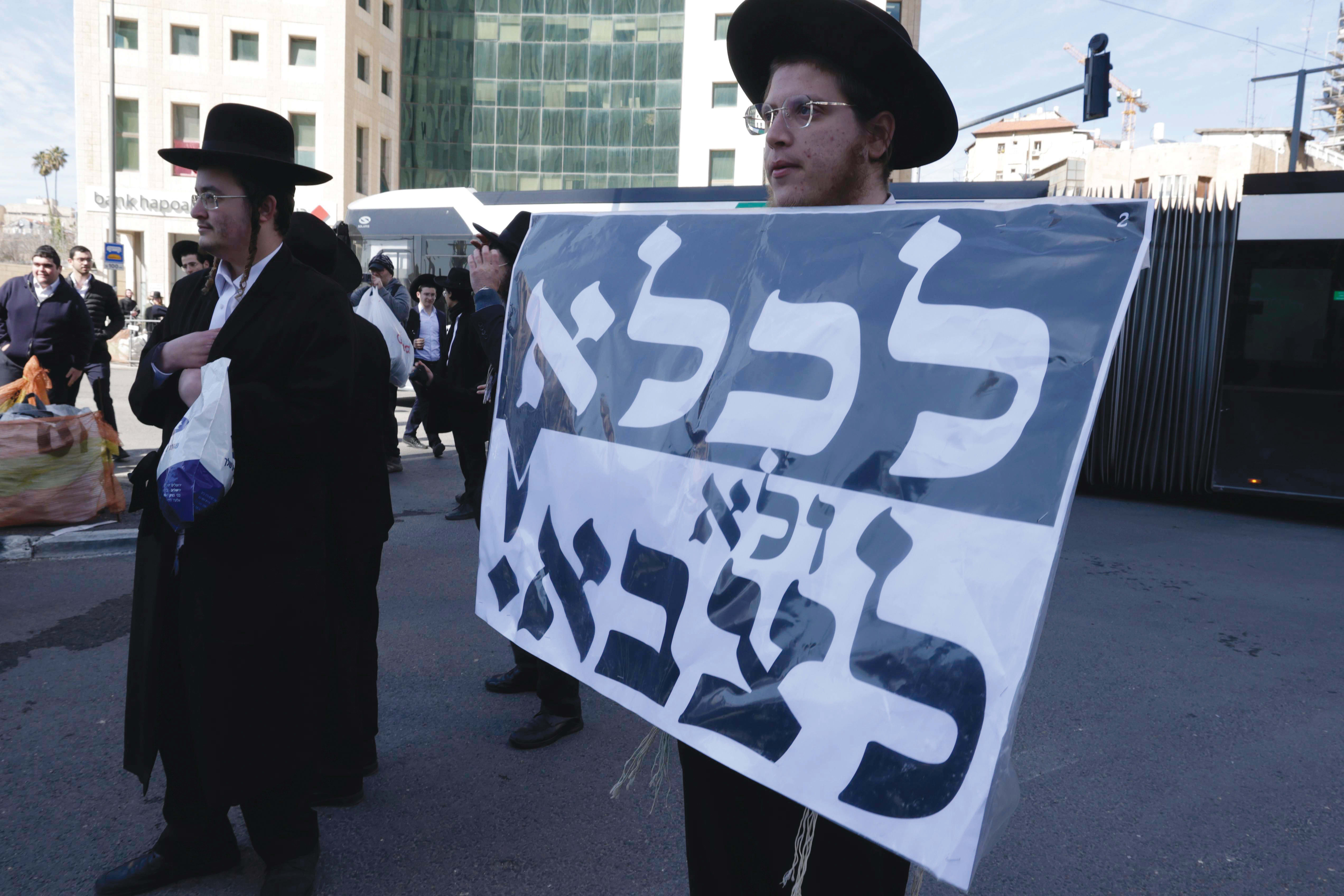  Haredi men are seen protesting the effort to draft ultra-Orthodox Israelis into the IDF. (photo credit: FLASH90)