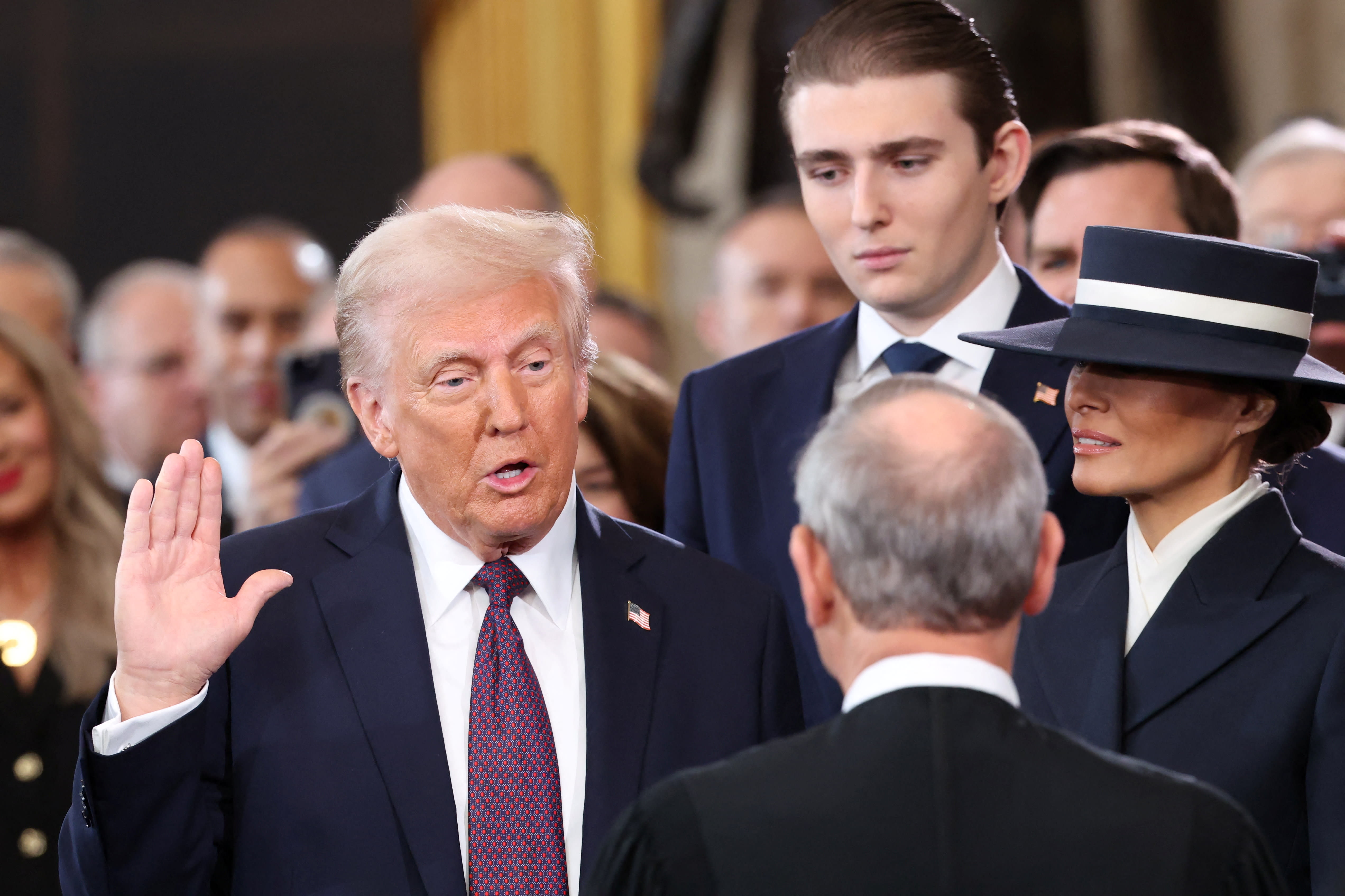 LOOKING ON with their son, Barron,  as husband Donald Trump takes the  presidential oath in the US Capitol in  Washington, Jan. 20, 2025. (photo credit: (Kevin Lamarque/Pool/Reuters))