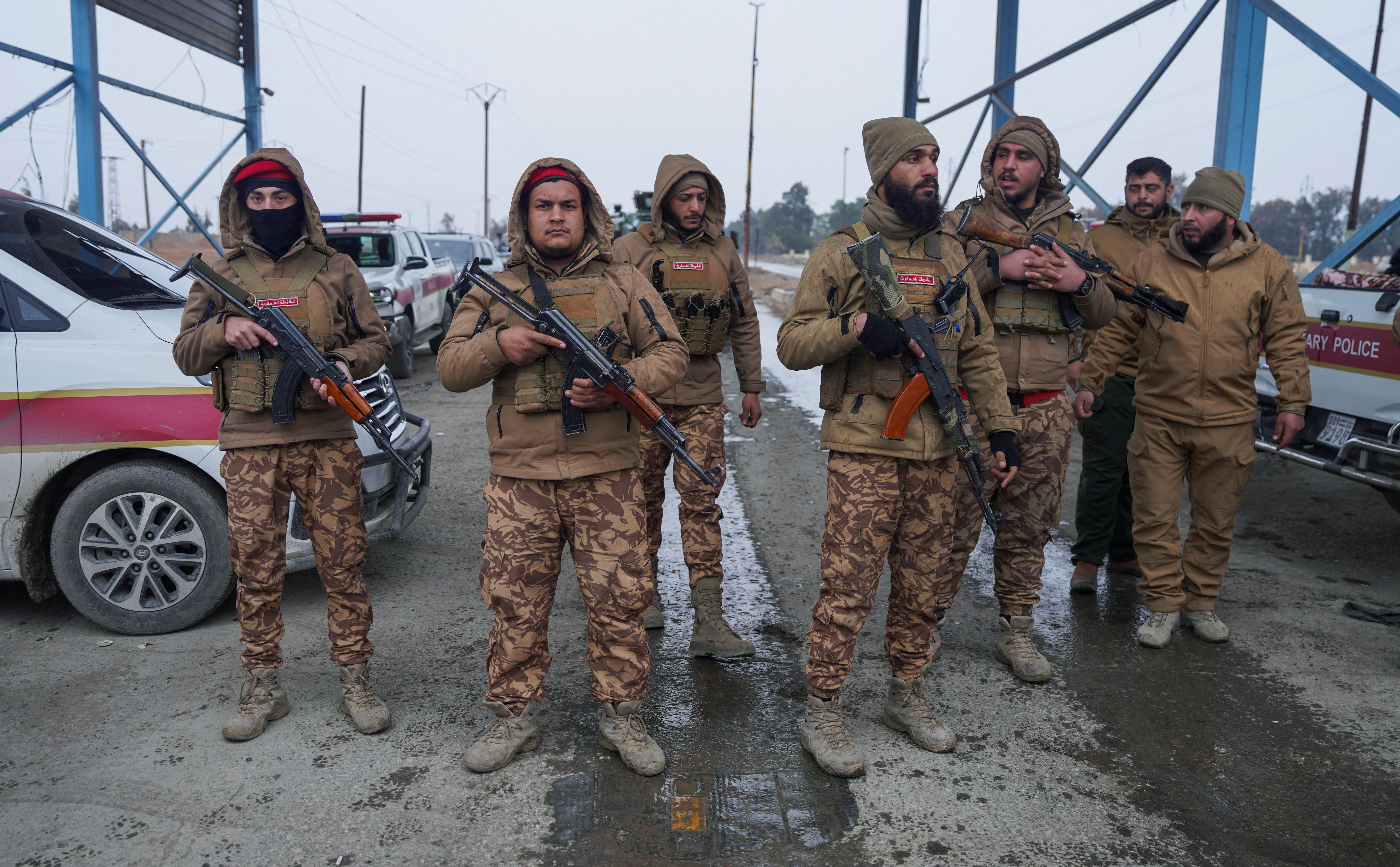 Members of the Syrian military police gather outside al-Aqtan prison, where some Islamic State detainees are held, in Raqqa, Syria January 22, 2026. (photo credit: REUTERS/KARAM AL-MASRI)