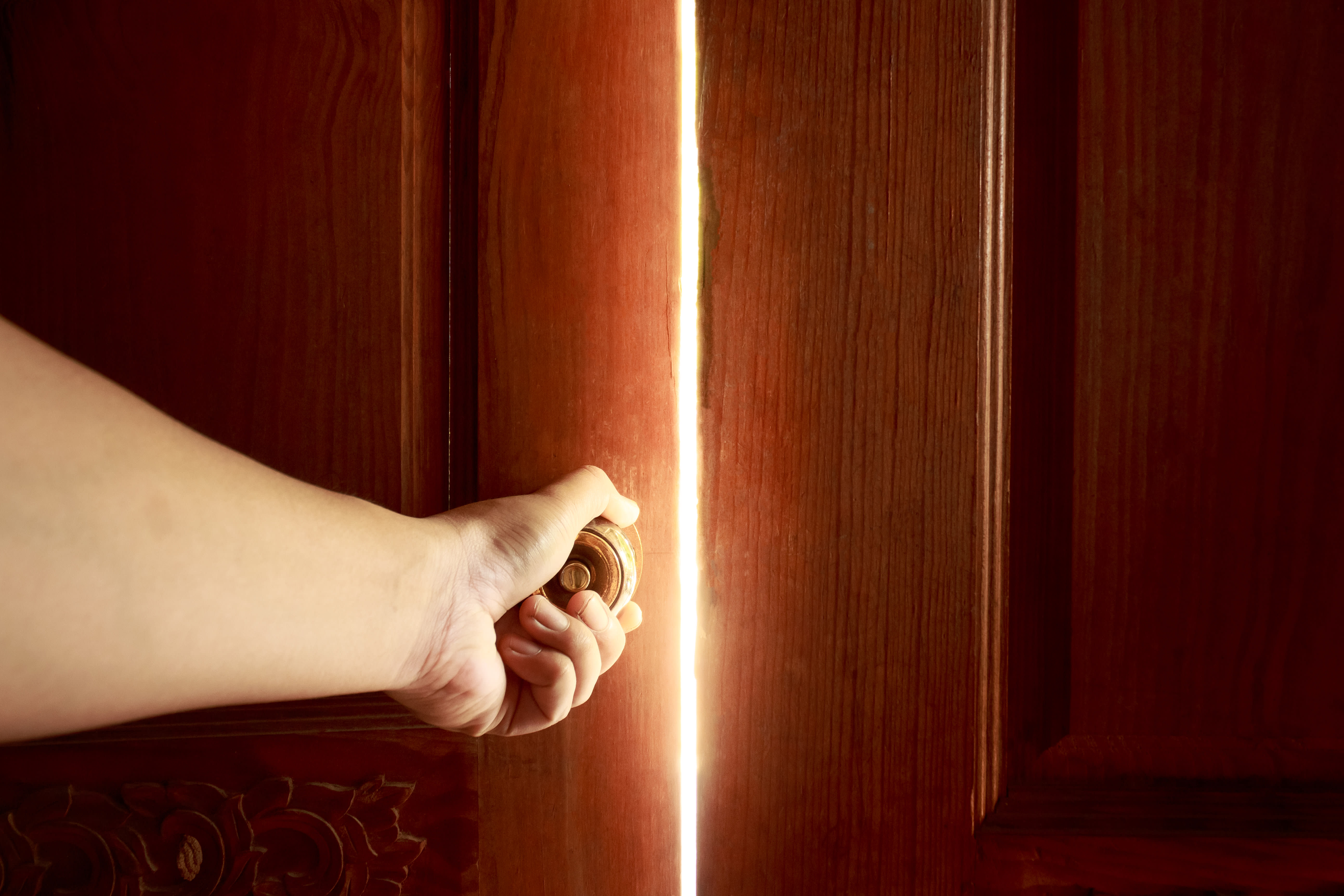 (Illustrative). Hand opens door to allow stream of light to enter. (photo credit: SHUTTERSTOCK)