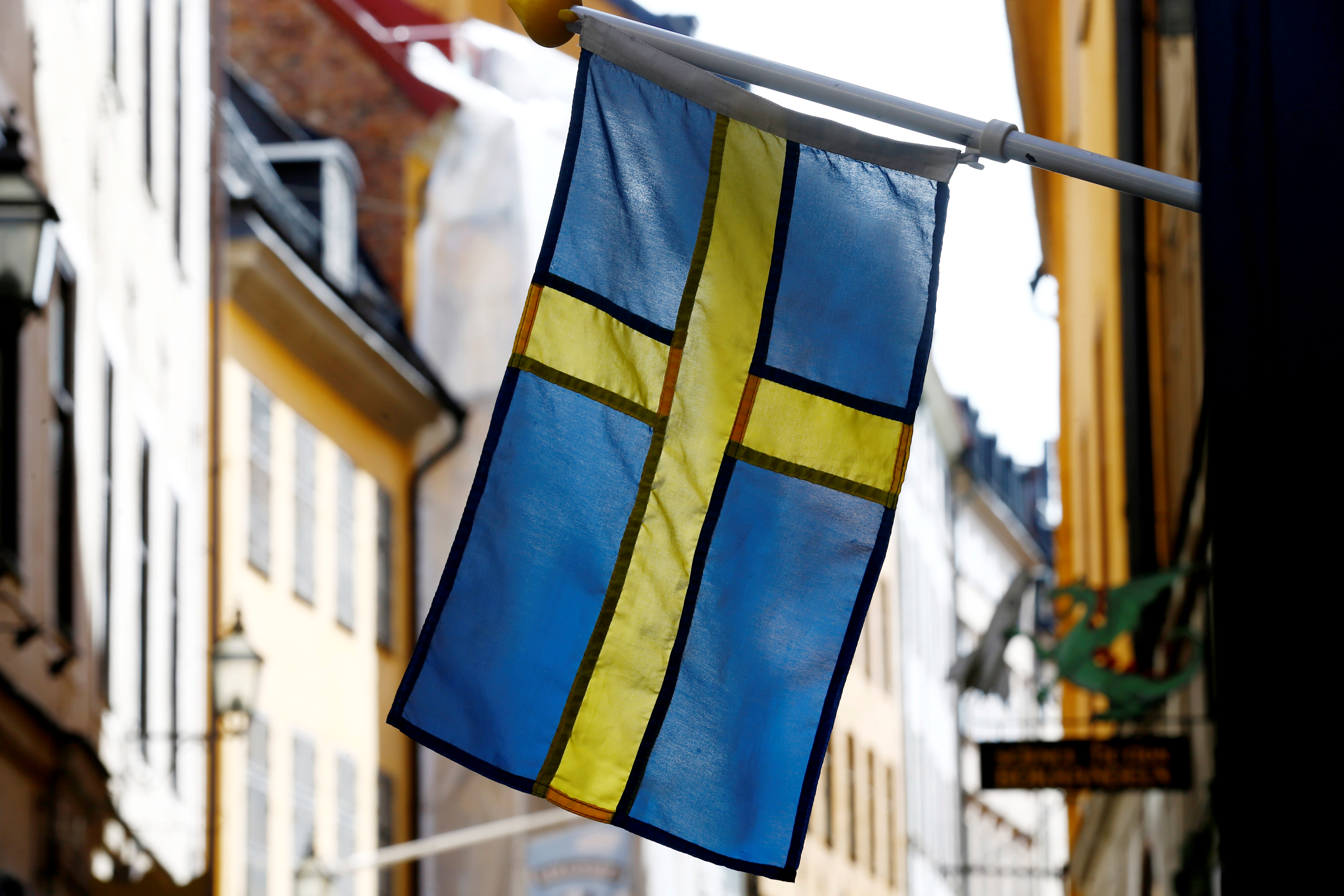 The Swedish flag is seen at Gamla Stan, the Old City of Stockholm, Sweden, May 7, 2017. (photo credit: INTS KALNINS / REUTERS)