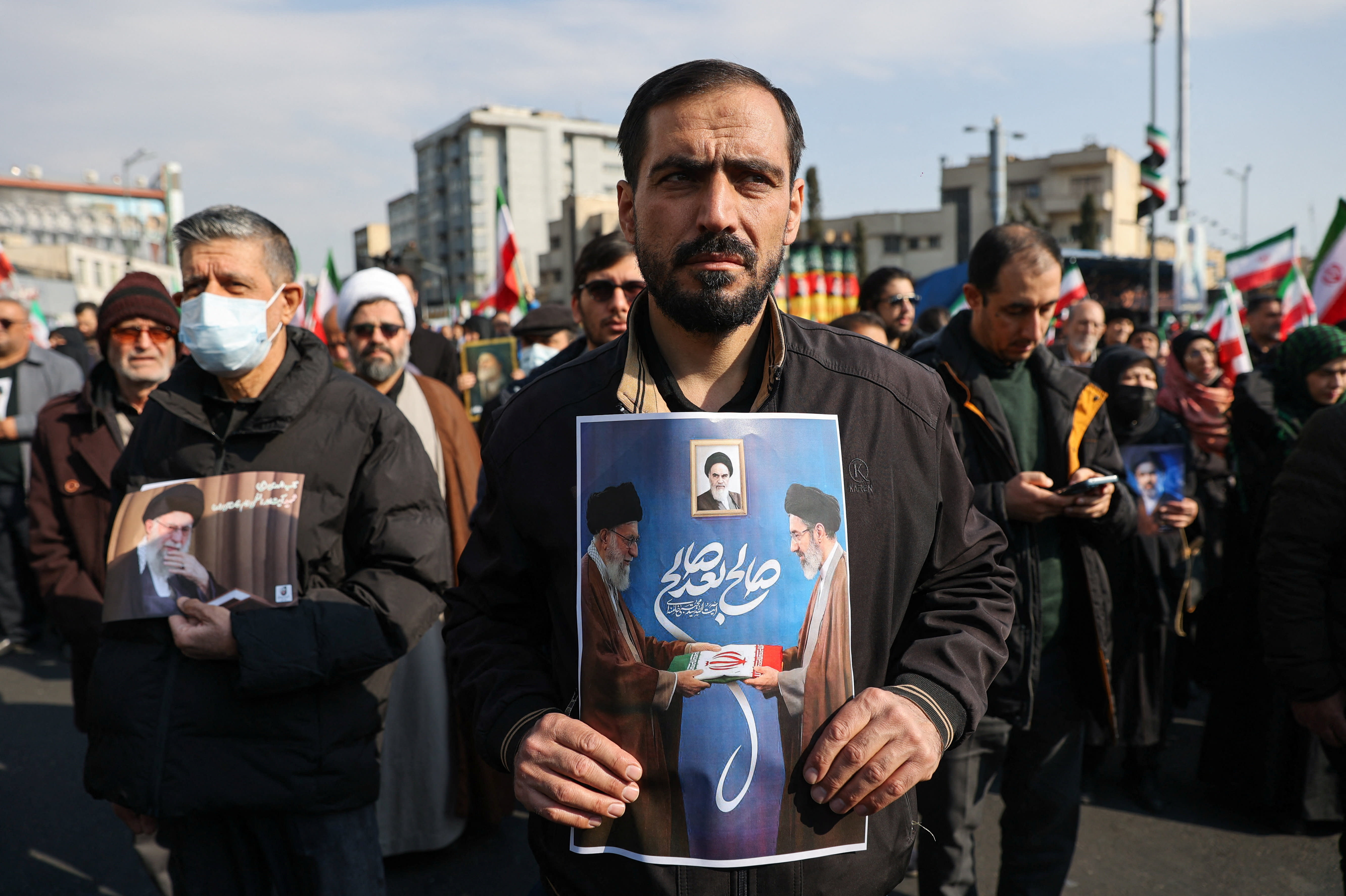 A man holds a placard with an image of Iran