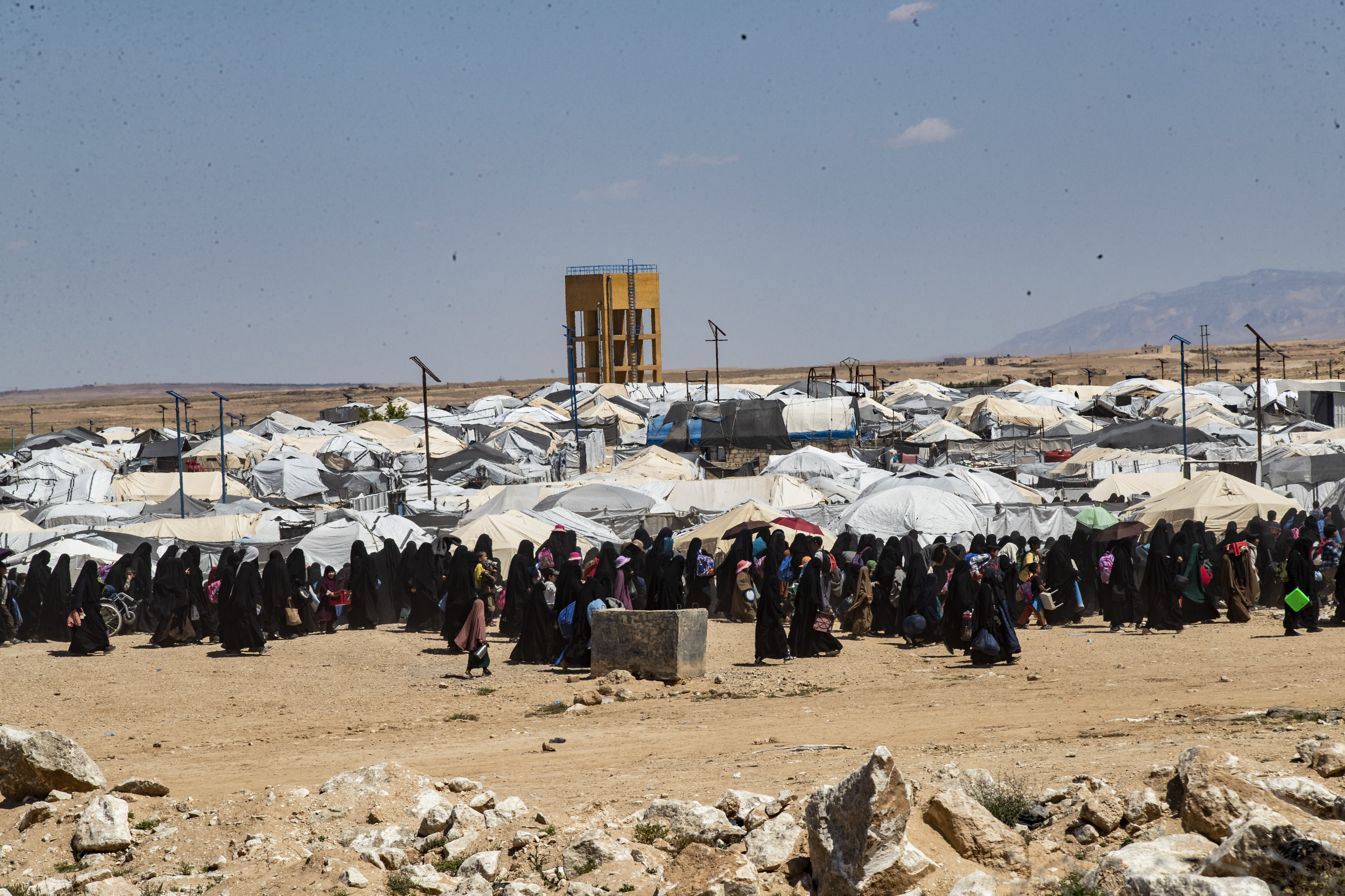 People walk at the Kurdish-run al-Hol camp, which holds relatives of suspected Islamic State (IS) group fighters in the northeastern Hasakeh governorate, on April 18, 2025. (photo credit: DELIL SOULEIMAN/AFP via Getty Images)