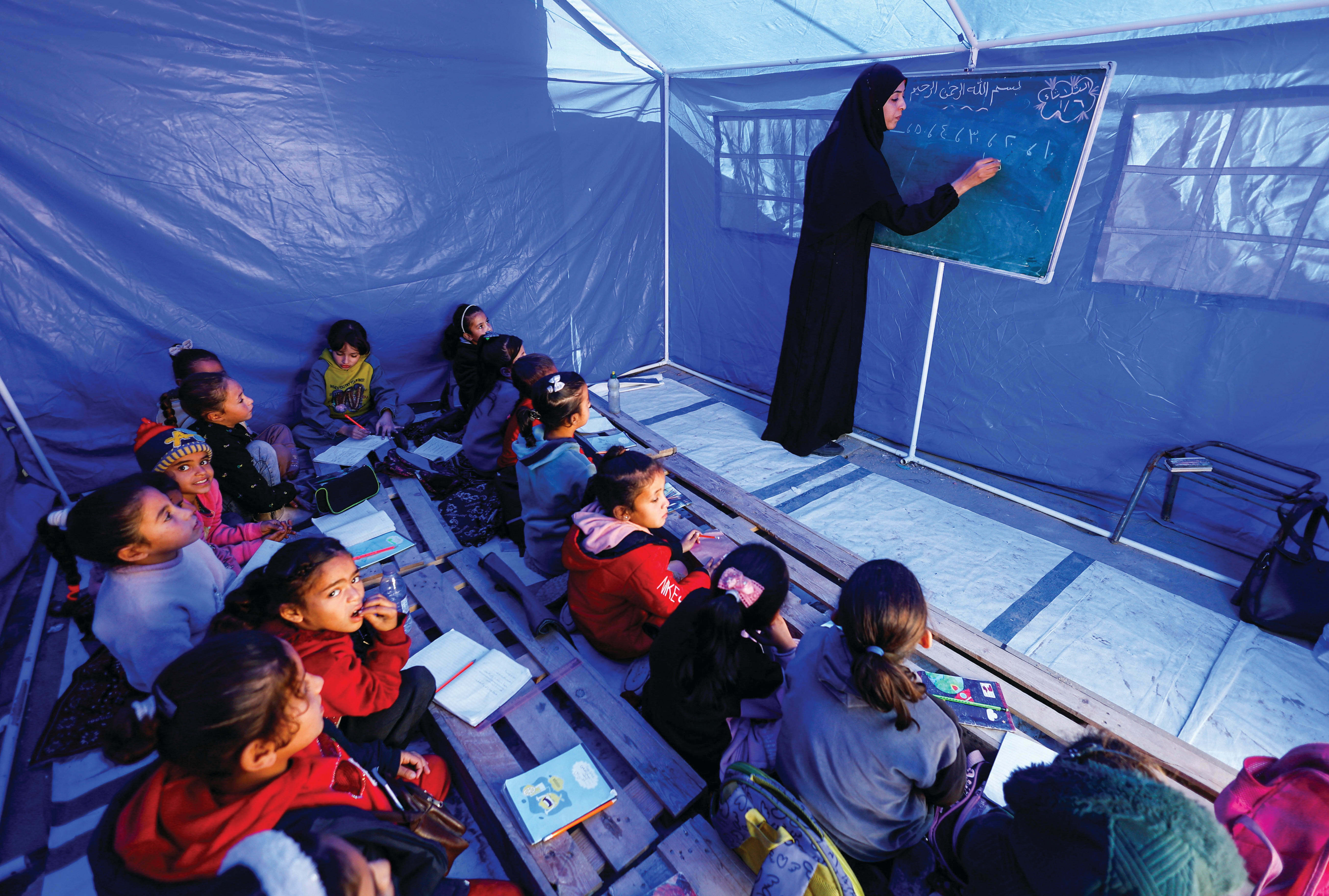 PALESTINIAN CHILDREN study inside a tent in the northern Gaza Strip. Education reform is critical to rebuilding Gaza, the writer says. (photo credit: Mahmoud Issa/Reuters)