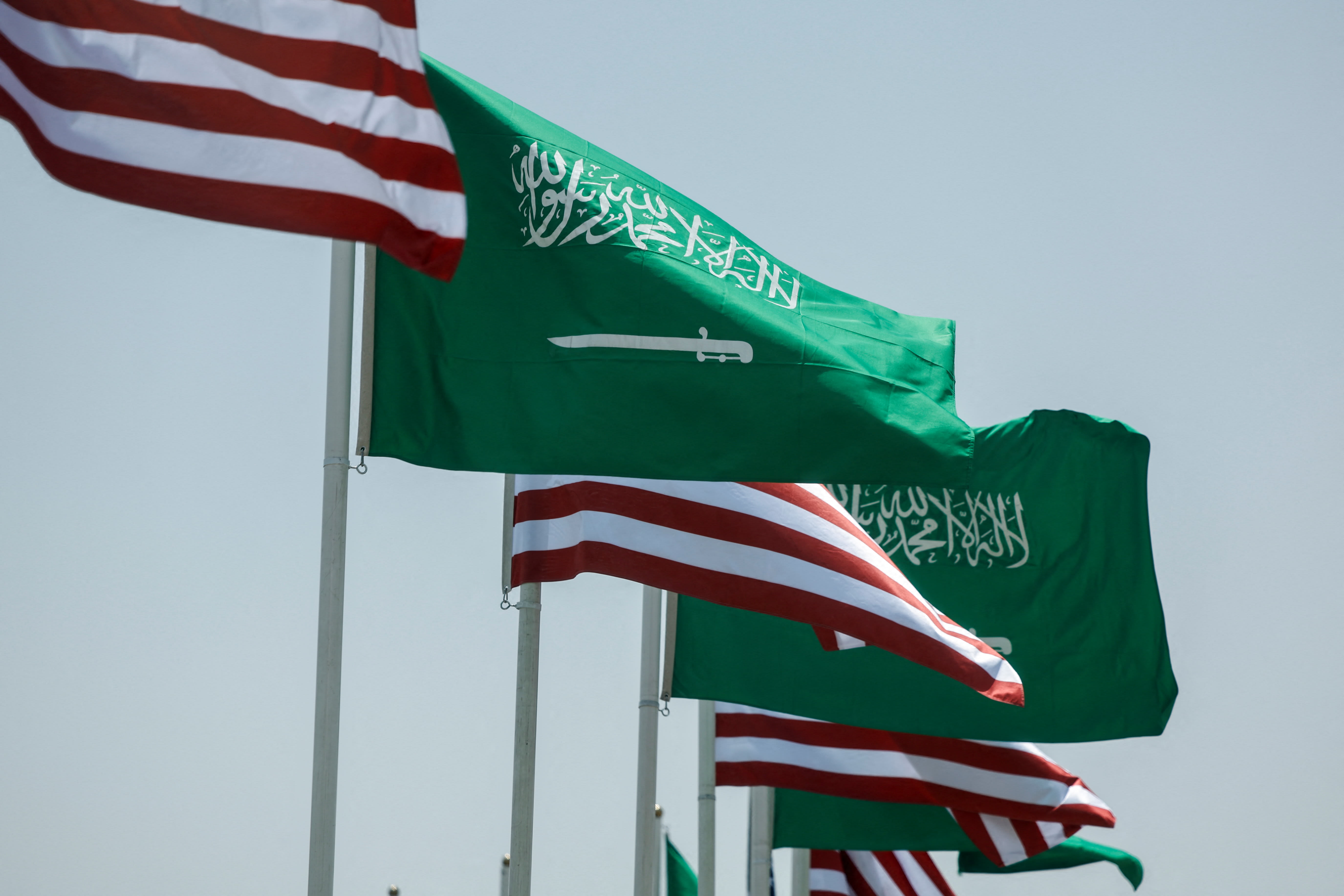US and Saudi flags flutter along a highway of Riyadh, as pictured through the glass of a car, ahead of the arrival of U.S. President Donald Trump to Riyadh, Saudi Arabia May 12, 2025. (photo credit: REUTERS/HAMAD I MOHAMMED)