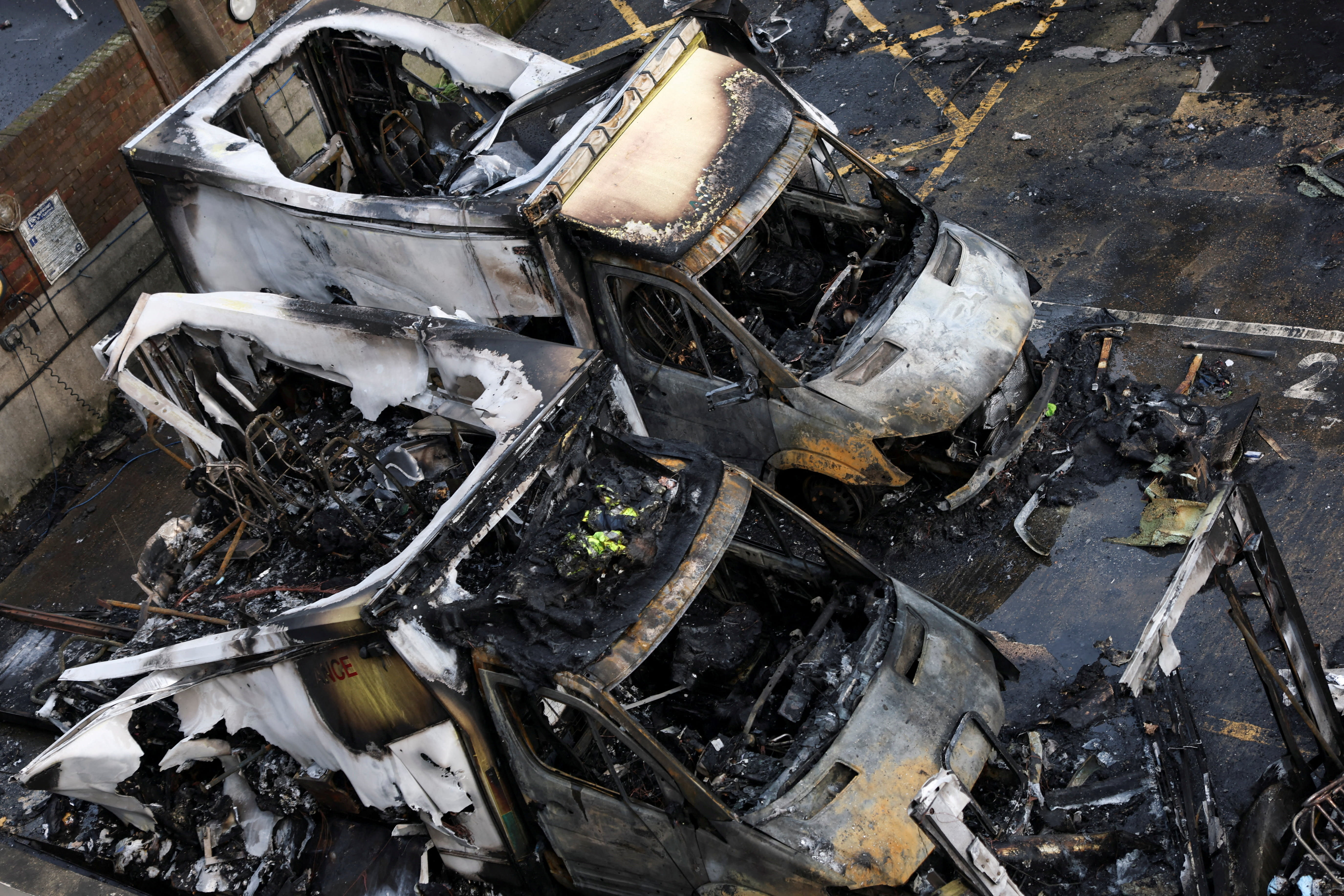 Charred remains of ambulances belonging to Hatzola, a Jewish community organisation, which were set on fire in an incident that the police say is being treated as an antisemitic hate crime, in northwest London, Britain, March 23, 2026. (photo credit: REUTERS/HANNAH MCKAY)