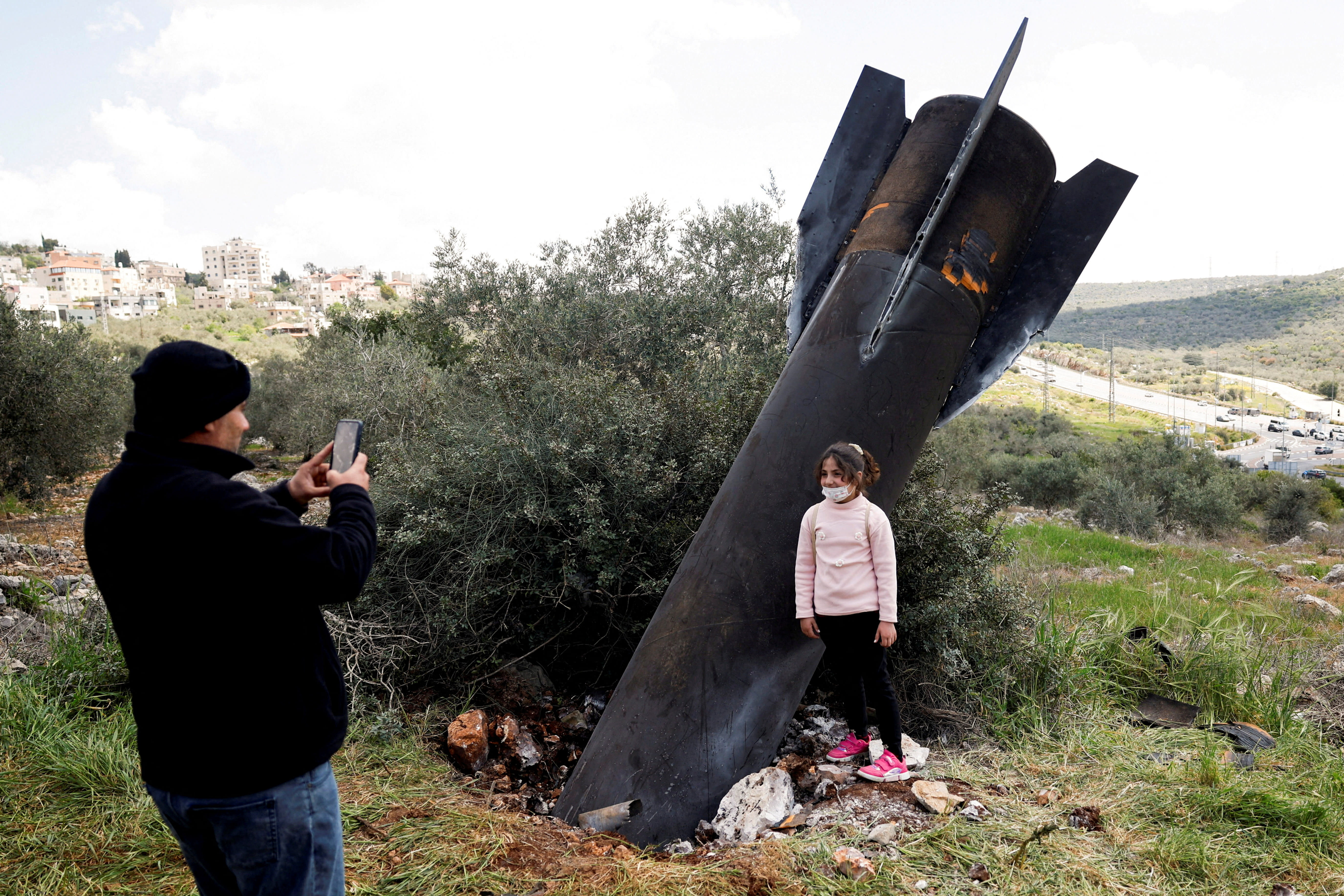 Huge Iranian missile fragments, intercepted by air defenses, lay scattered across Israel, West Bank