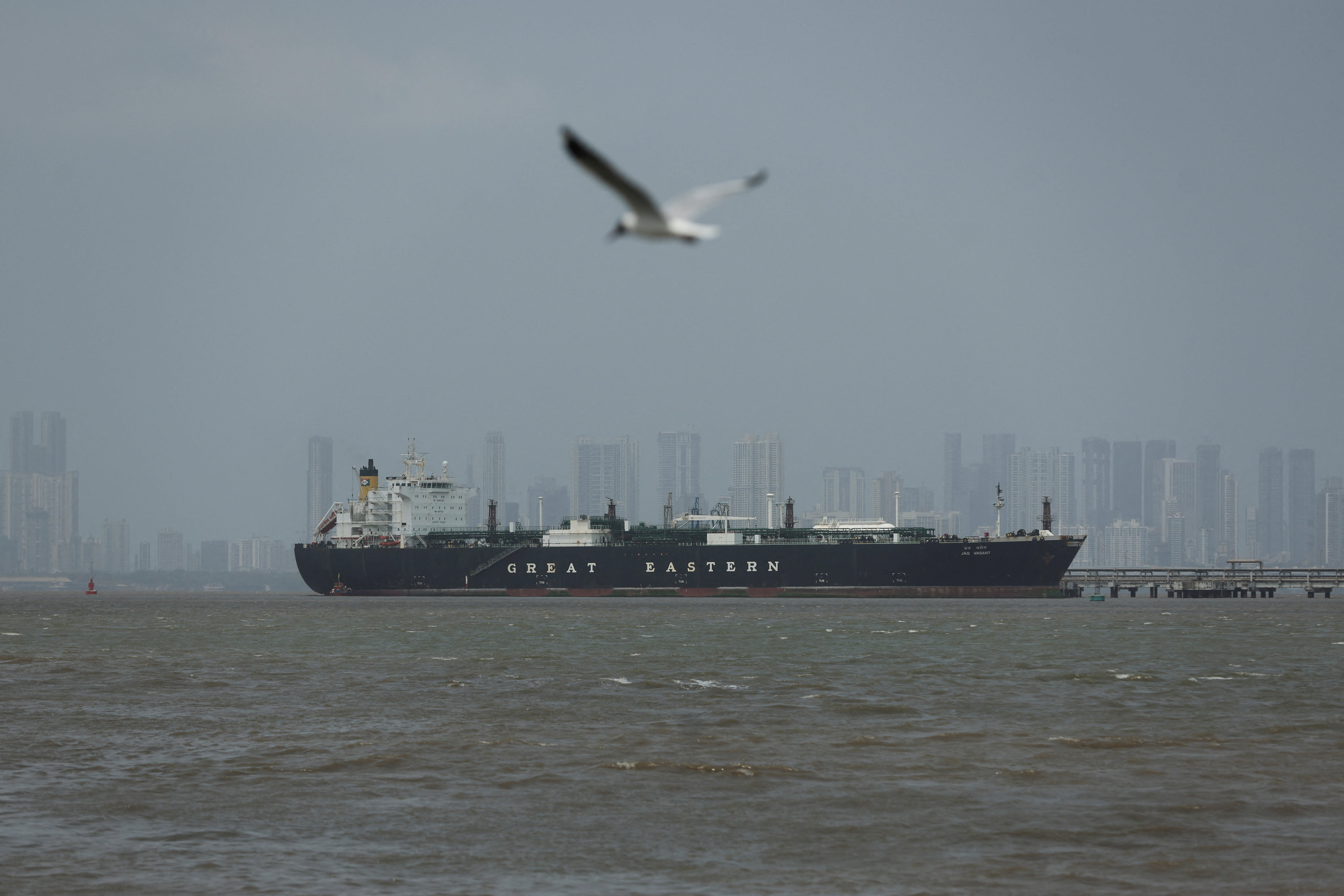 A bird flies near the Jag Vasant vessel transferring LPG at a port after transiting the Strait of Hormuz amid supply disruptions linked to the U.S-Israeli conflict with Iran, in Mumbai, India, April 1, 2026.  (photo credit: Francis Mascarenhas/Reuters)