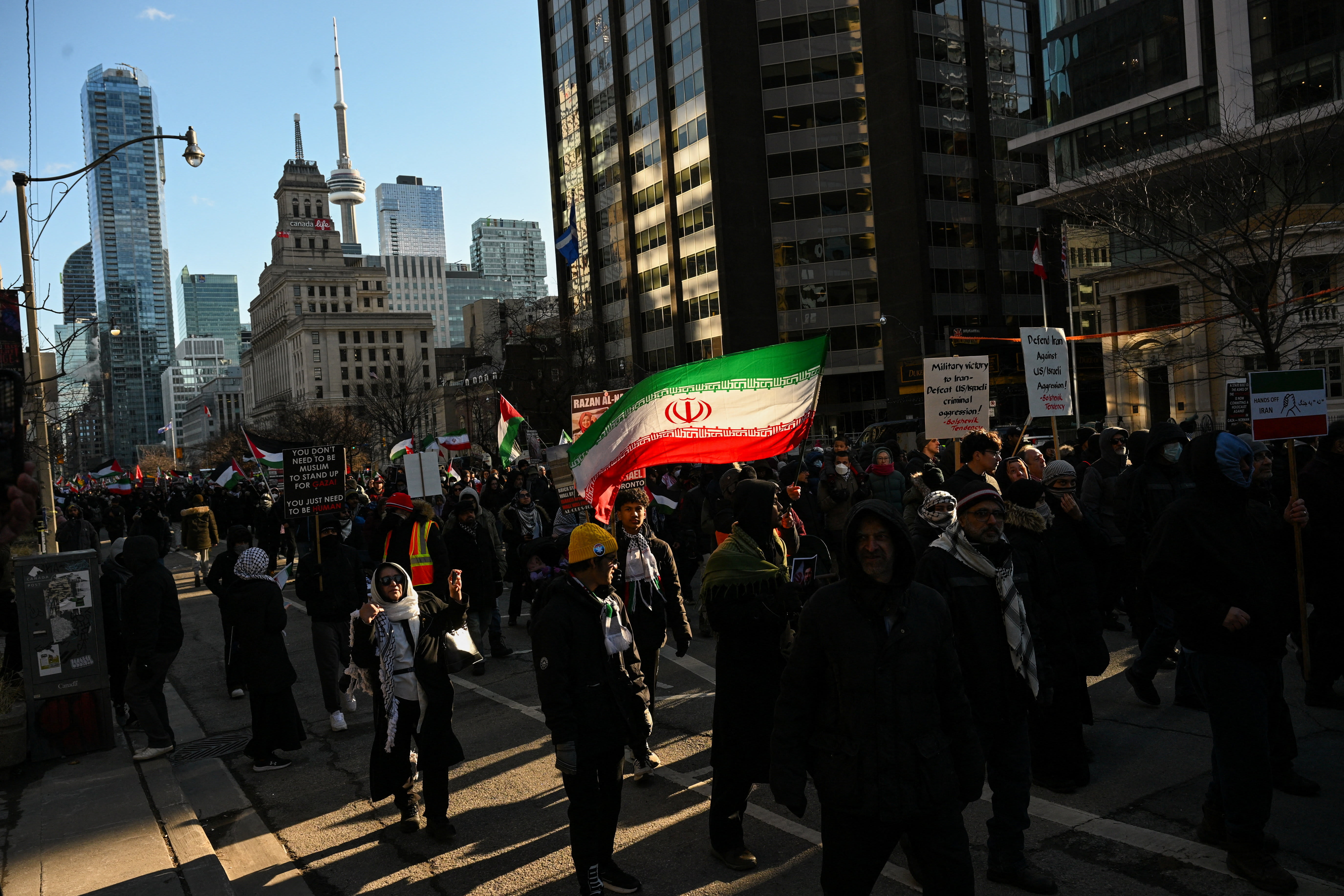 PROTESTERS MARCH at a rally marking Al-Quds Day and opposing the war on Iran and Lebanon in downtown Toronto, Ontario, Canada, March 14, 2026.  (photo credit: REUTERS/Laura Proctor )