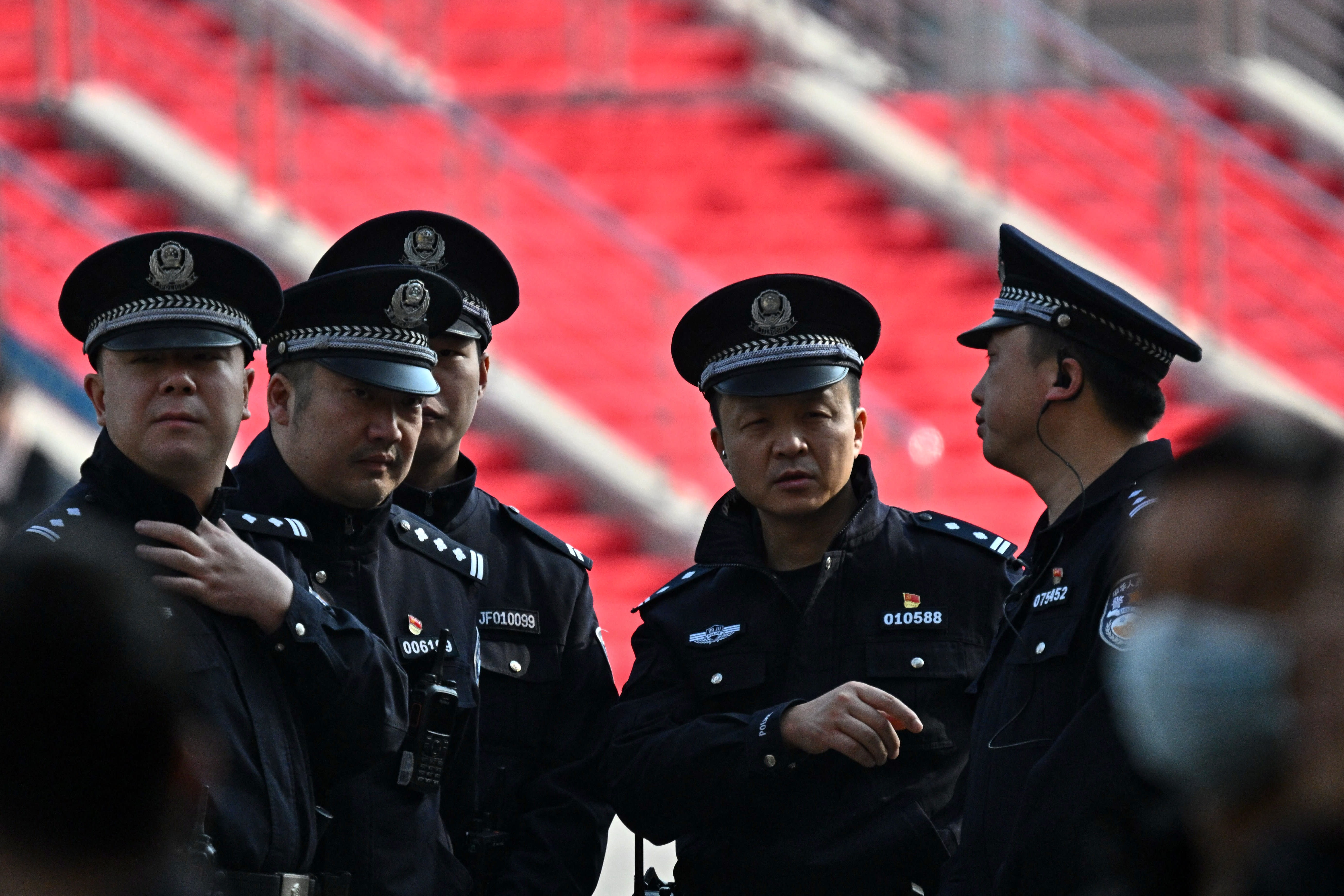 Police stand guard ahead of the arrival of French President Emmanuel Macron at the University of Sichuan for a meeting with students in Chengdu, in southwestern China