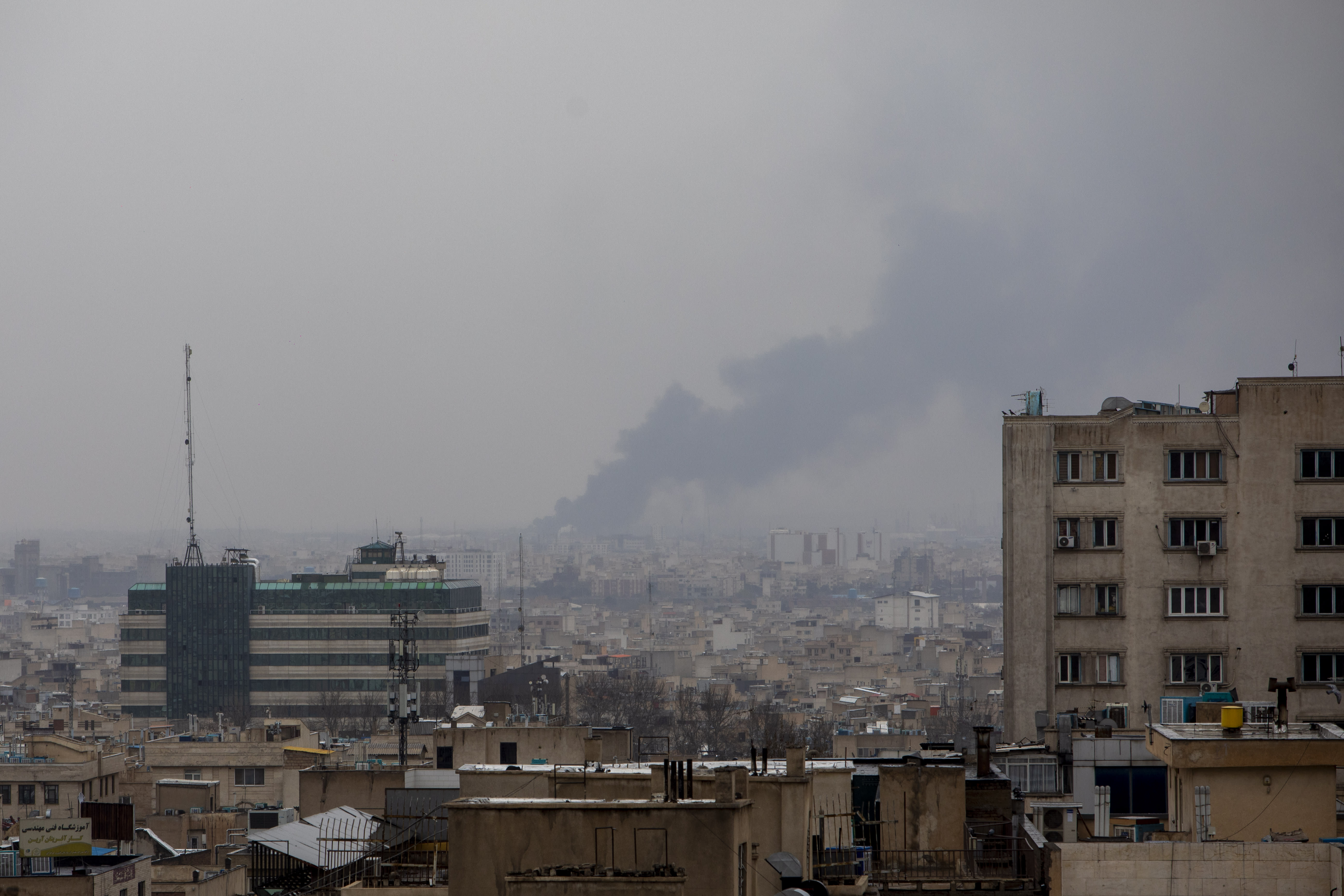 Smoke rises in the distance following an airstrike at the same time a Quds Day demonstration takes place on March 13, 2026 in Tehran, Iran. (photo credit: Majid Saeedi/Getty Images)
