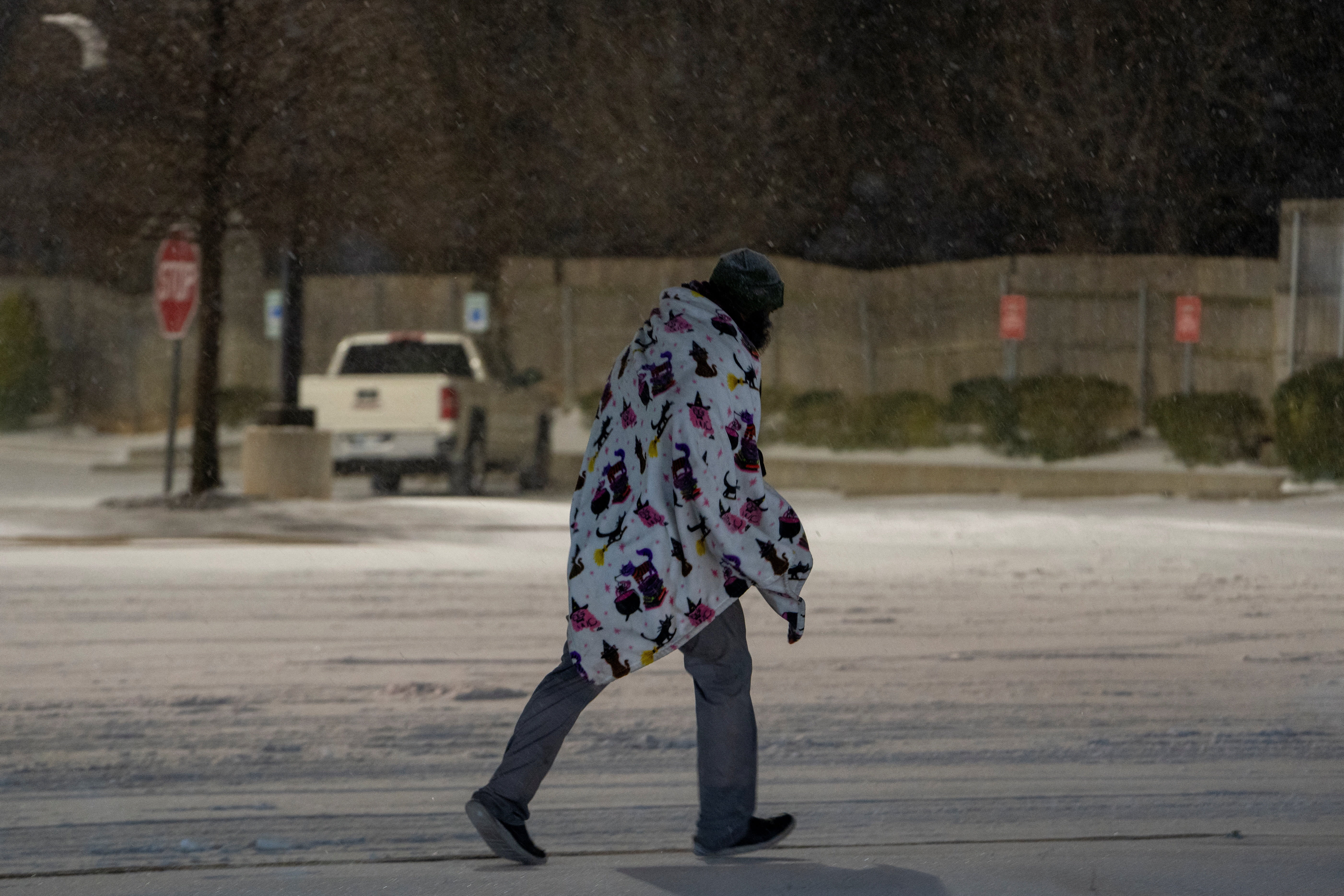 A man walks through the snow as Winter Storm Fern arrives in Oklahoma City, Oklahoma, US, January 23, 2026. (photo credit: REUTERS/Nick Oxford)
