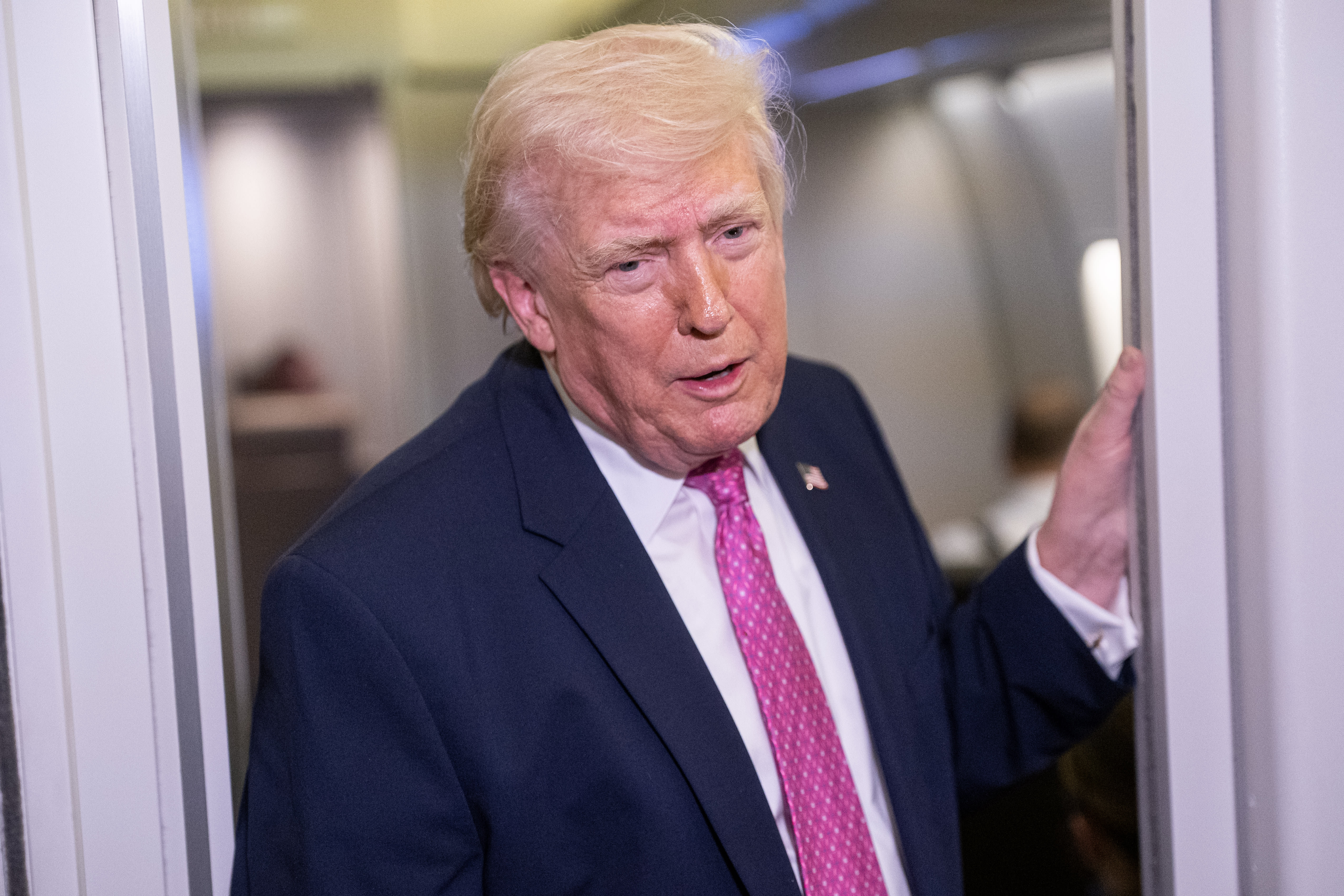 US President Donald Trump speaks with members of the media onboard Air Force One on March 29, 2026 while en route to Joint Base Andrews, Maryland from West Palm Beach Florida. (photo credit: Nathan Howard/Getty Images)