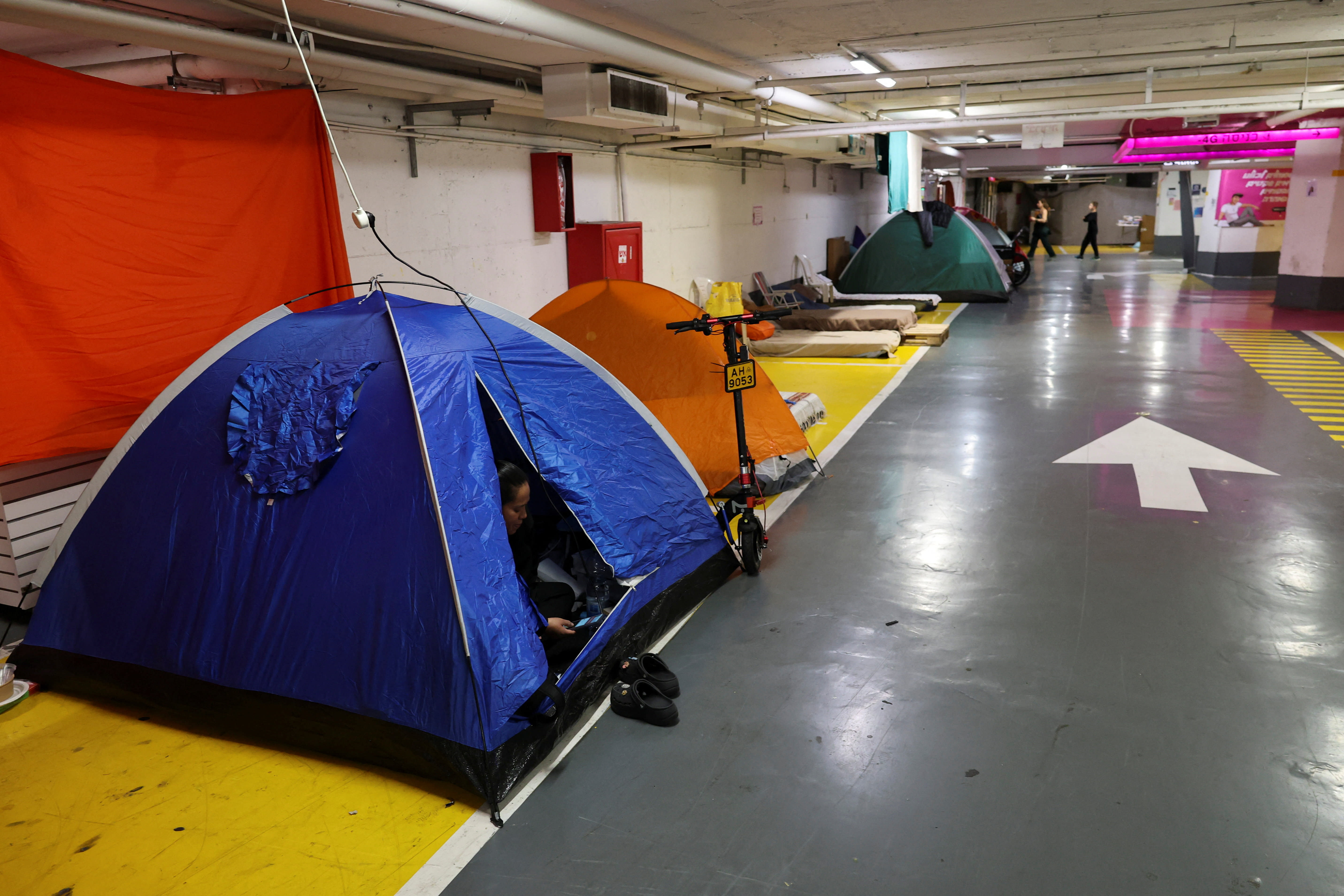 TENTS ARE set in an underground parking garage used as a public bomb shelter in Tel Aviv last month. (photo credit: AMMAR AWAD/REUTERS)