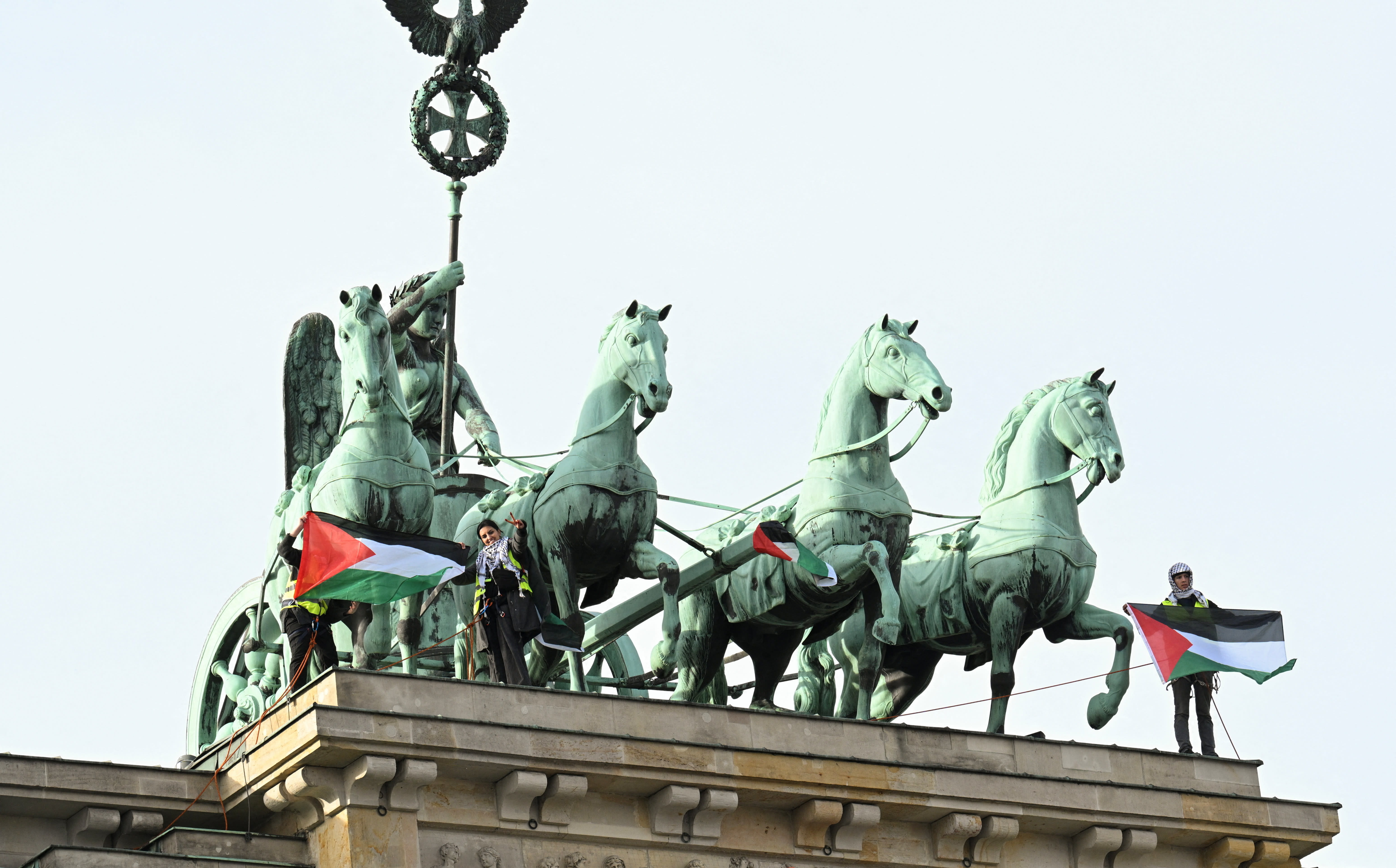 Pro-Palestinian supporters stand on top of the Brandenburg Gate in Berlin, Germany, in November 2025.  (photo credit: Annegret Hilse/Reuters)