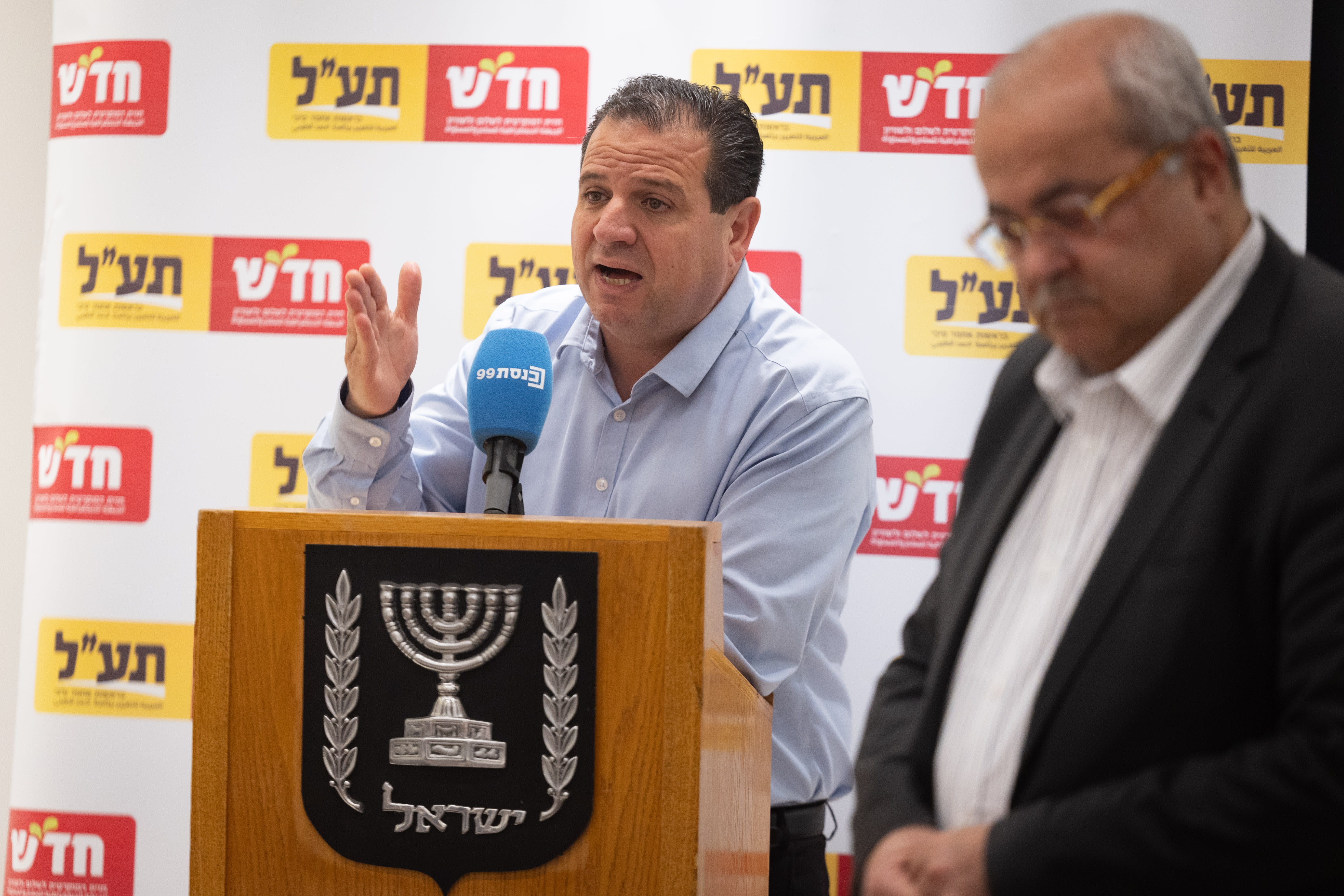 Arab MK Ayman Odeh (at the plenum) and MK Ahmad Tibi (in the foreground) attend a Hadash-Ta