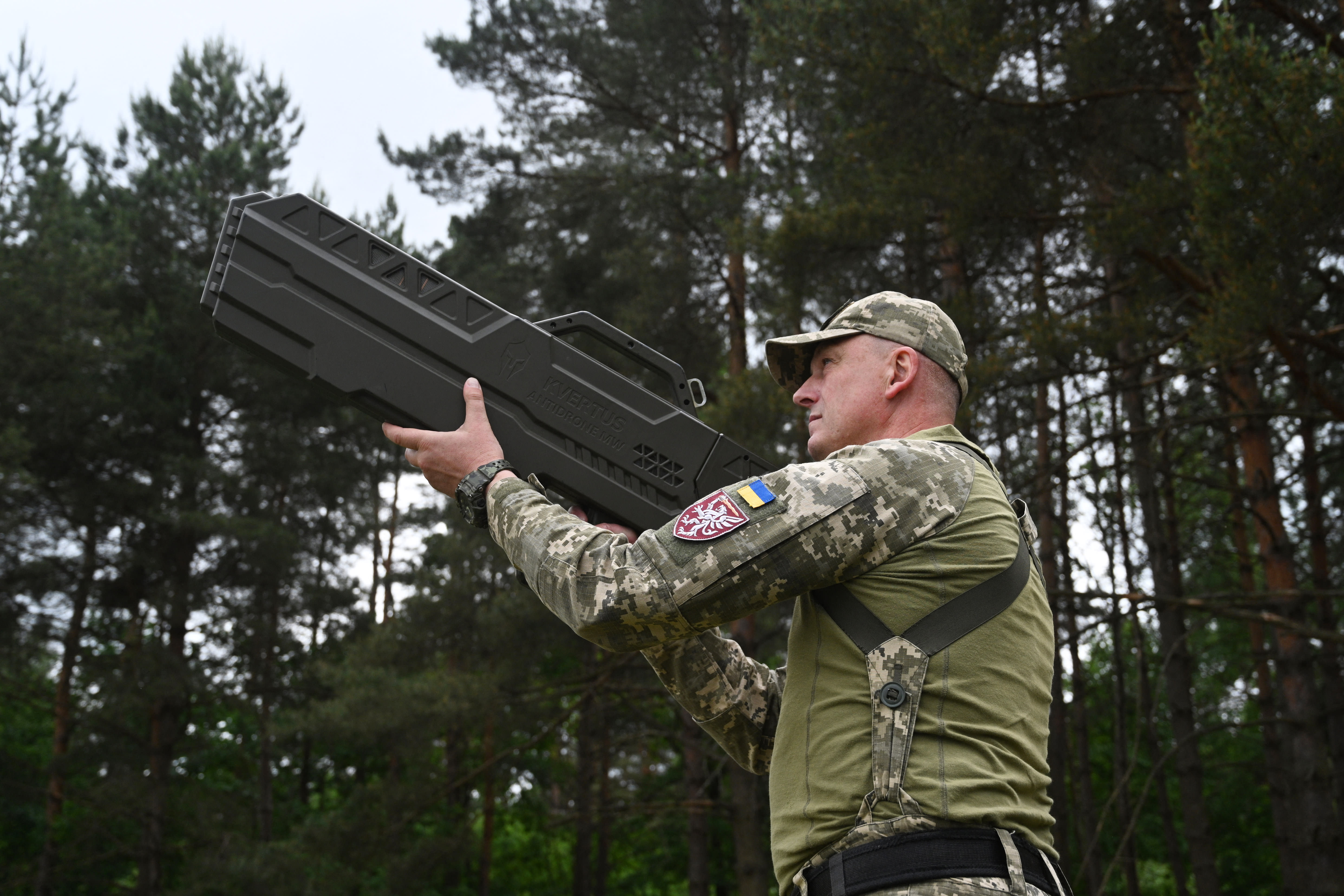 A Ukrainian serviceman tests an anti-drone gun during a presentation of radio-electronic warfare (WB) and radio-electronic intelligence (PER) systems of the Ukrainian company Kvertus in Lviv region on May 28, 2024. (photo credit: YURIY DYACHYSHYN/AFP via Getty Images)