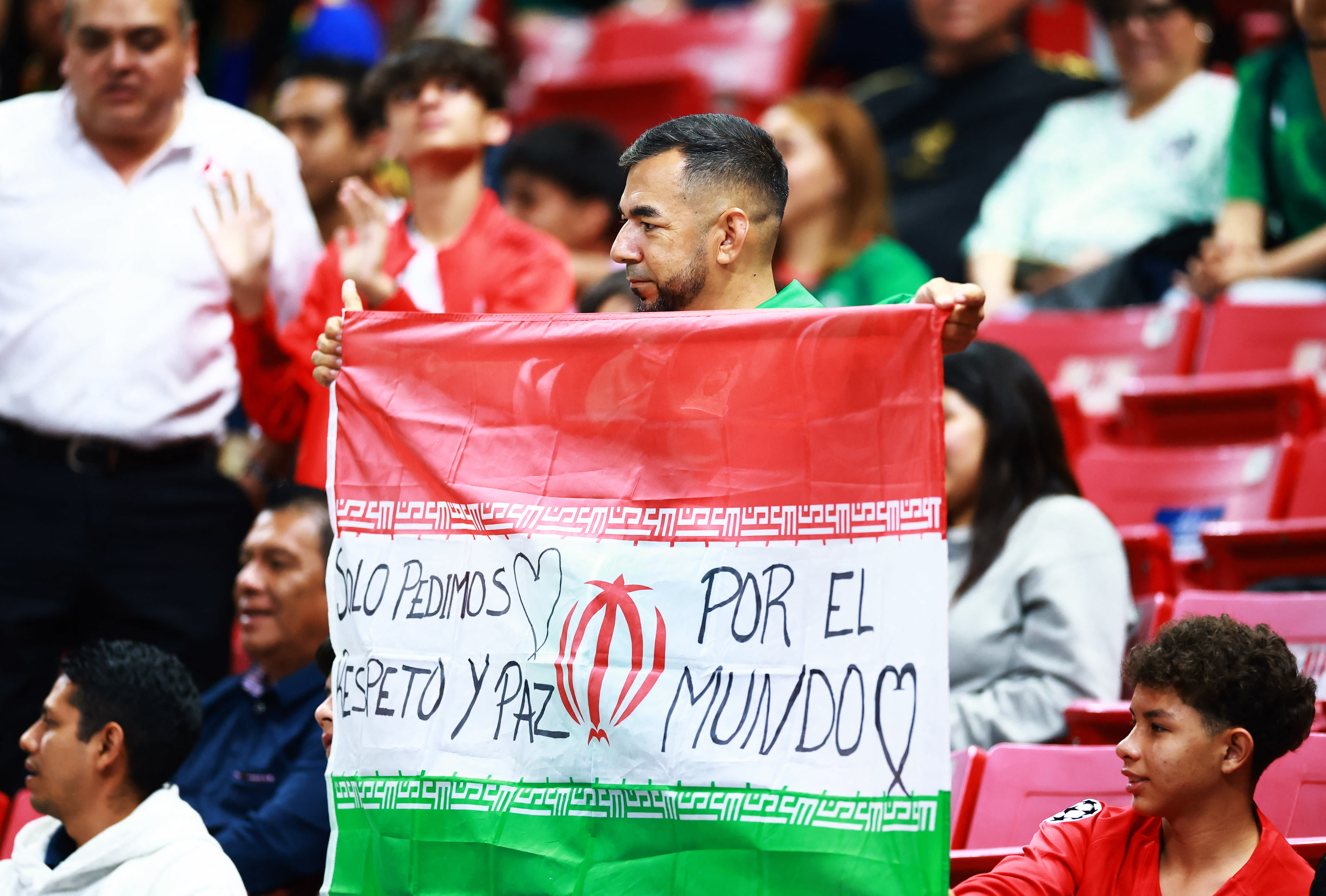 FIFA World Cup - Inter-Confederation Playoffs - Semi Final - New Caledonia v Jamaica - Estadio Guadalajara, Guadalajara, Mexico, A fan holds up the flag of Iran in the stands before the match. - March 26, 2026. (photo credit: REUTERS/Eloisa Sanchez)