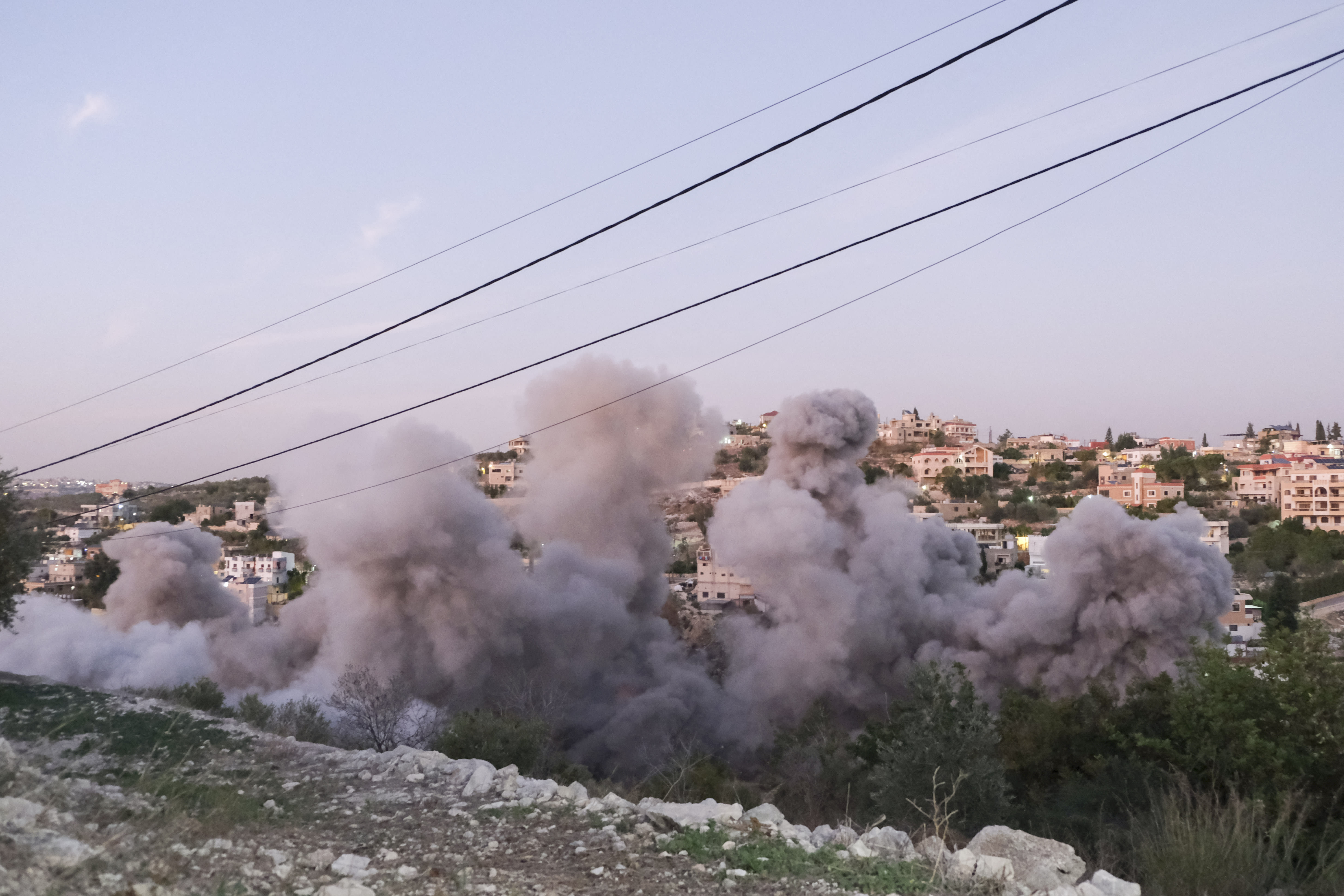 Flames and smoke errupt from the site of an Israeli airstrike that targeted a house in the southern Lebanese village of Tair Filsay on November 19, 2025. (photo credit: COURTNEY BONNEAU/Middle East Images/AFP via Getty Images)