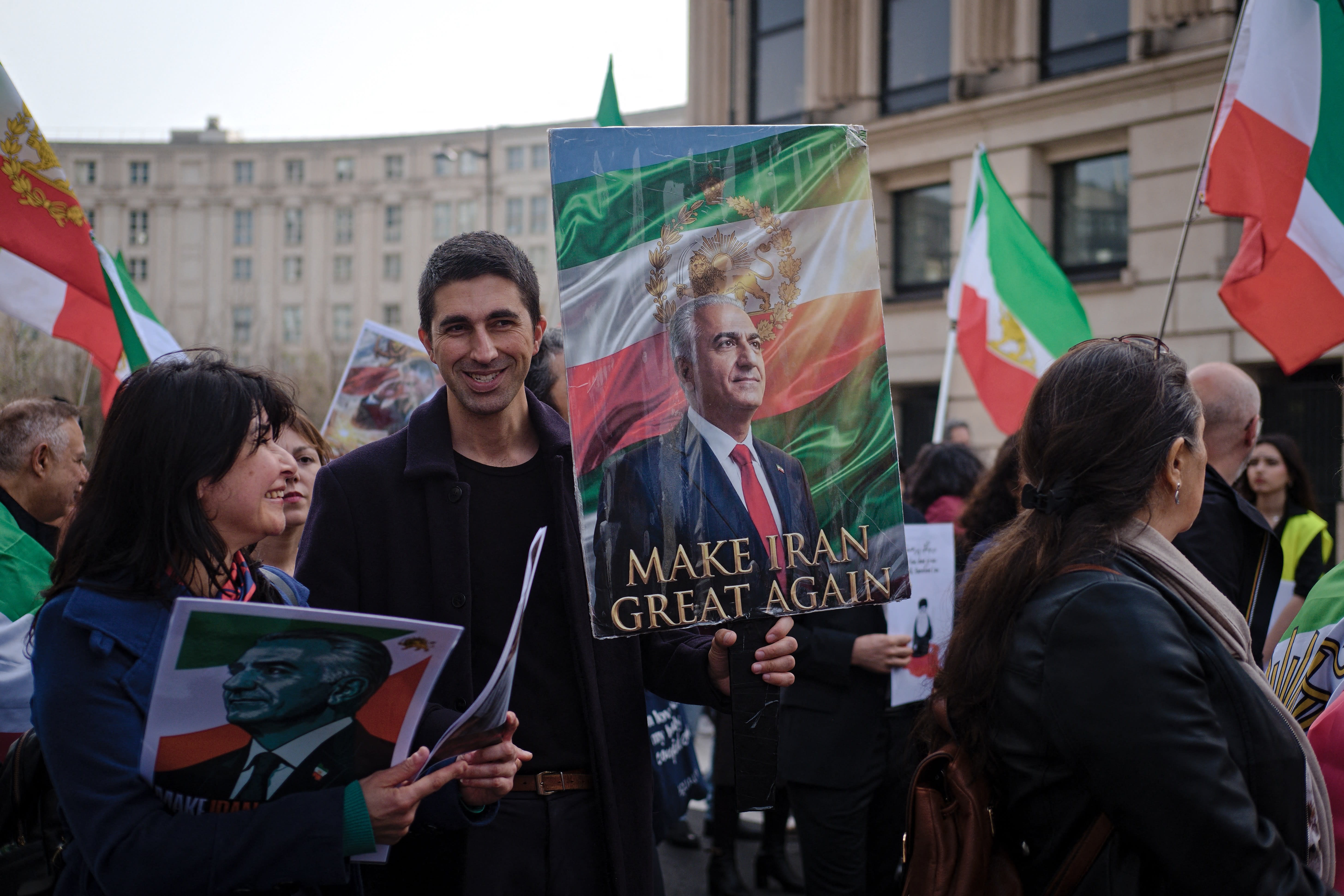 Protesters wave flags of Imperial Iran and hold signs in support of exiled Crown Prince Reza Pahlavi at a demonstration in support of the Iranian people in Paris, France, on March 7. (photo credit: Djoudi Hamani/Hans Lucas/AFP via Getty Images)