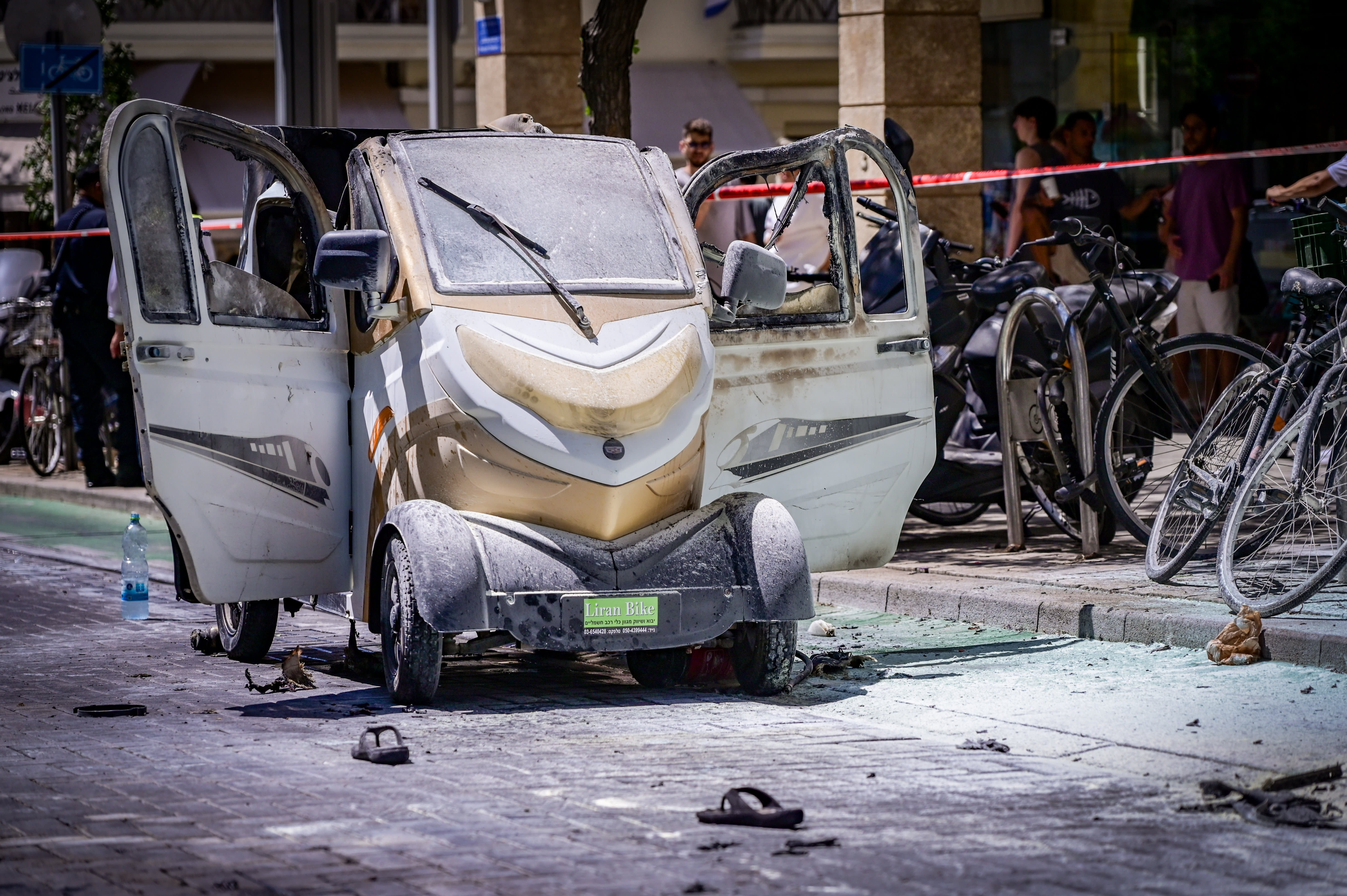 Security and rescue forces at the scene where an electric vehicle caught fire from its battery in Tel Aviv, July 29, 2024. (photo credit: AVSHALOM SASSONI/FLASH90)