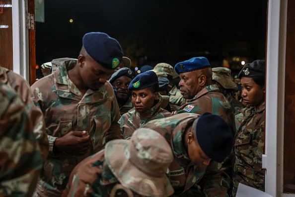South African National Defence Force (SANDF) soldiers queue to mark a register upon arrival at Tempe Military Base in Bloemfontein on June 14, 2025, following their withdrawal from eastern Democratic Republic of Congo. (photo credit: PHILL MAGAKOE/AFP via Getty Images)