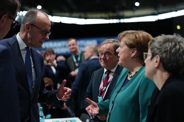 Chancellor Merz greets Merkel at CDU federal congress in Stuttgart, Feb 20, 2026. (photo credit: Kay Nietfeld - Pool/Getty Images)