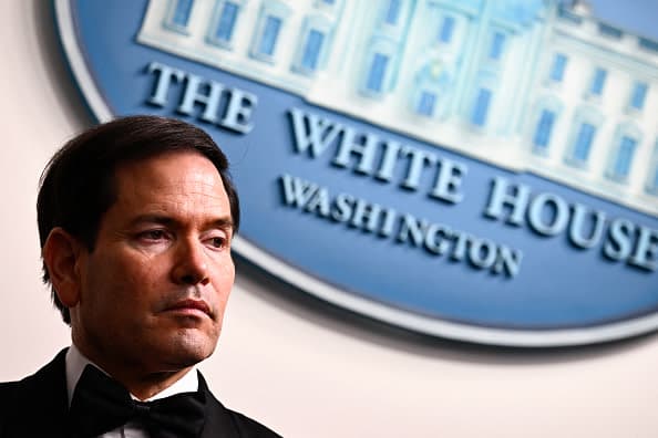 US Secretary of State Marco Rubio listens to US President Donald Trump speak during a press briefing in the Brady Briefing Room at the White House in Washington, DC, shortly after a shooting incident at the White House Correspondents