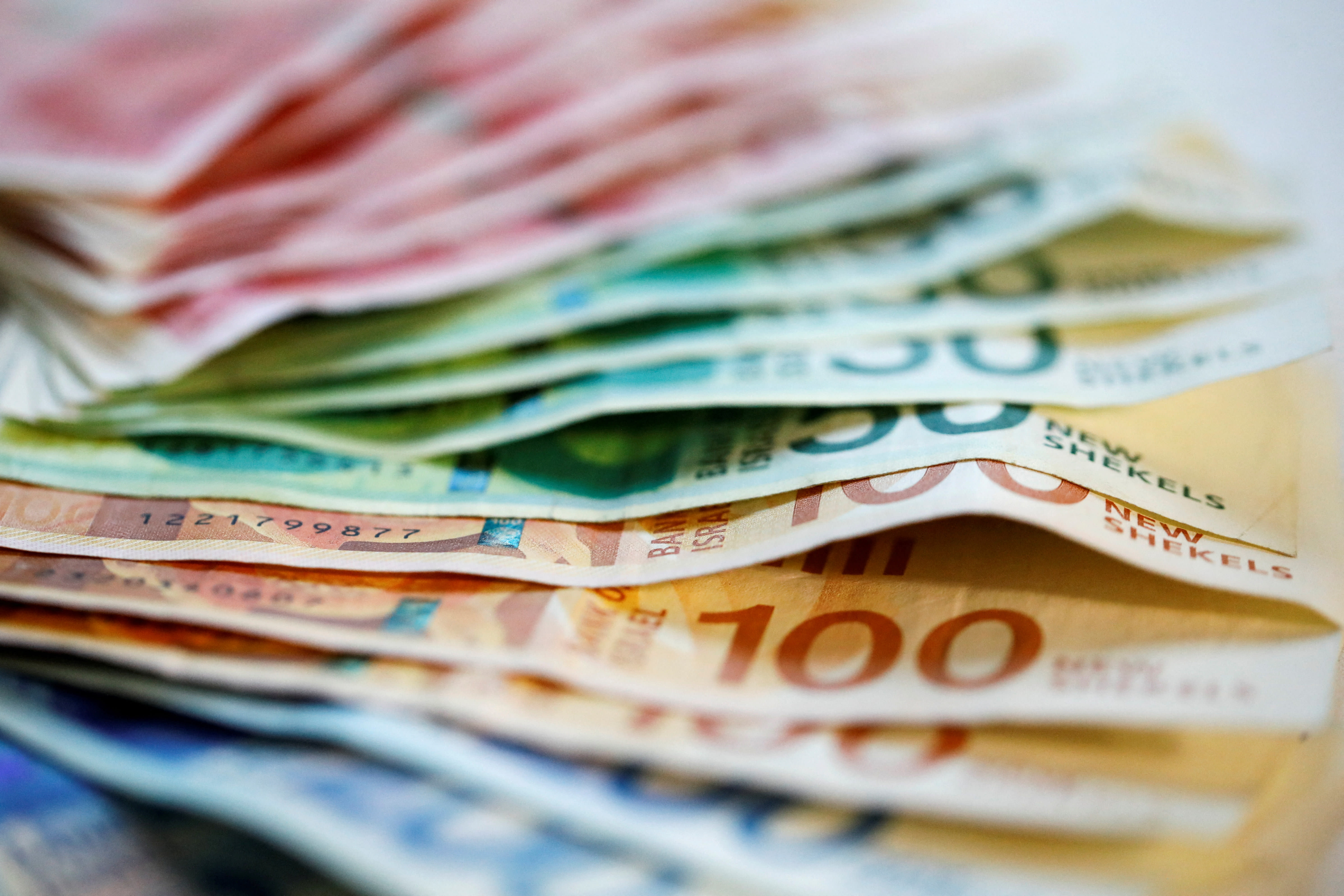 New Israeli Shekel banknotes are seen in this picture illustration taken November 9, 2021. (photo credit: REUTERS/Nir Elias/Illustration/File Photo)