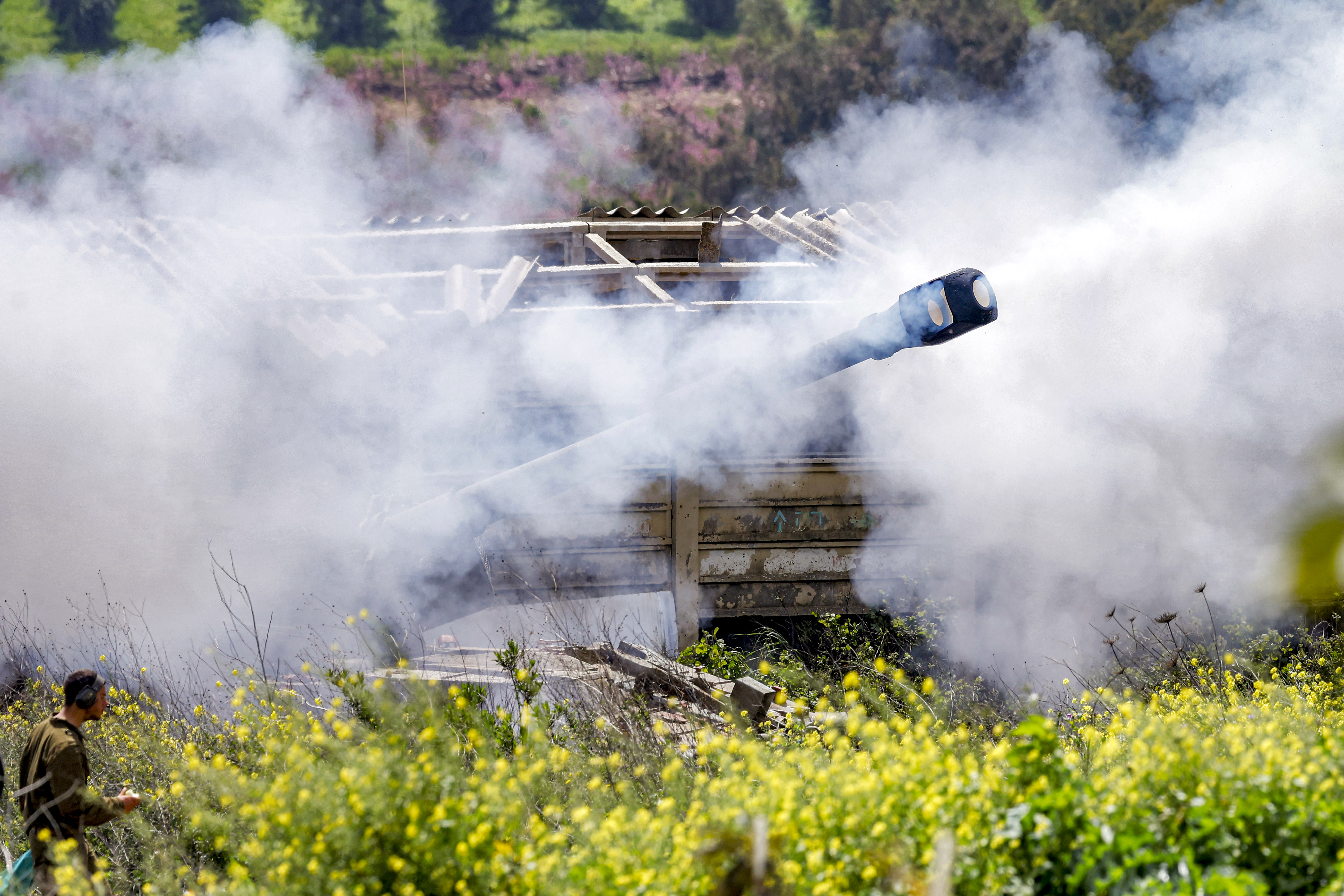 Smoke is released after an Israeli army self-propelled Howitzer artillery gun fires rounds from the upper Galilee in northern Israel near the border with southern Lebanon on March 27, 2026. (photo credit: Jalaa MAREY / AFP via Getty Images)