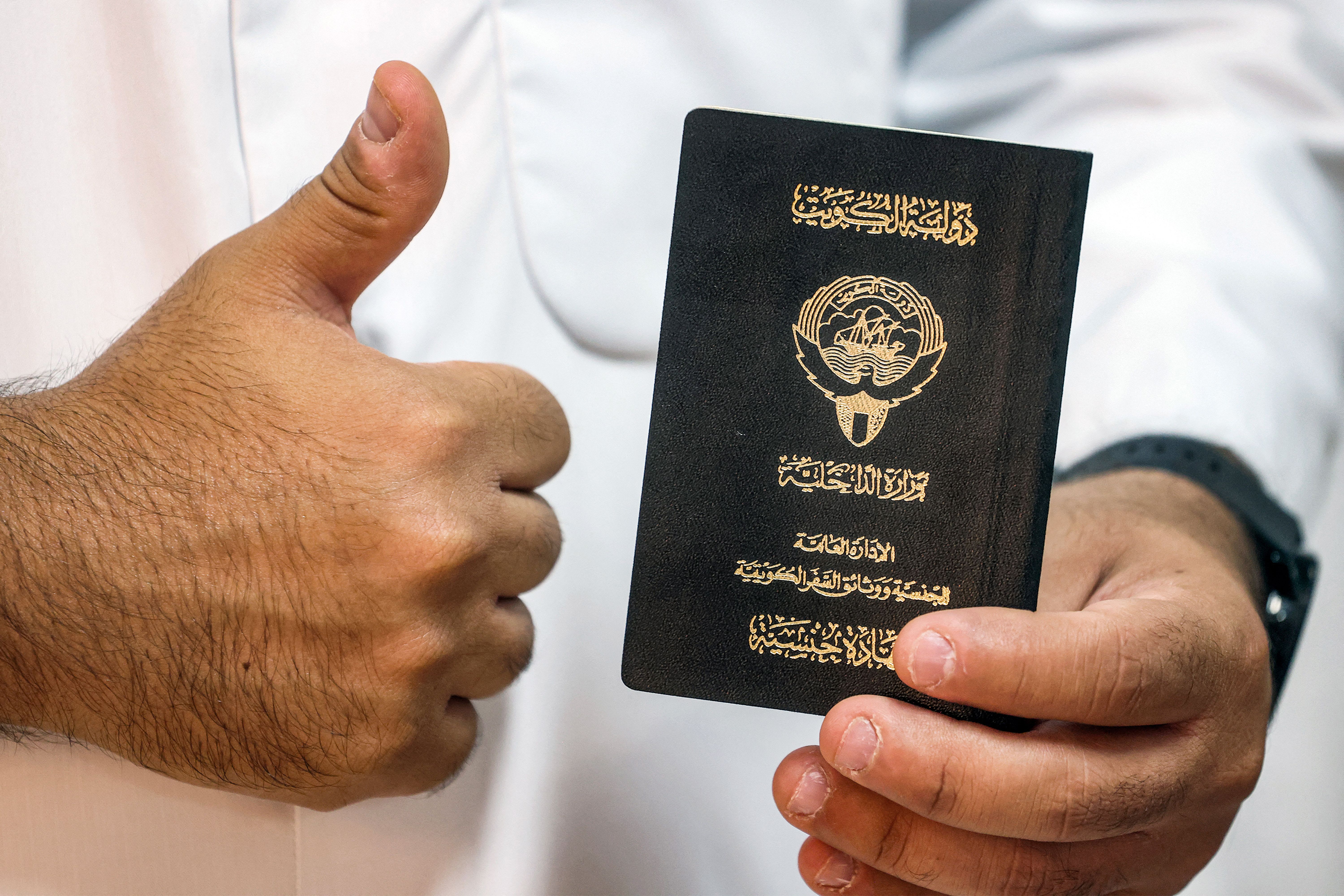  A voter holds his proof of Kuwaiti citizenship upon arriving at a polling station during parliamentary elections in Kuwait City on June 6, 2023. (photo credit:  YASSER AL-ZAYYAT/AFP via Getty Images)