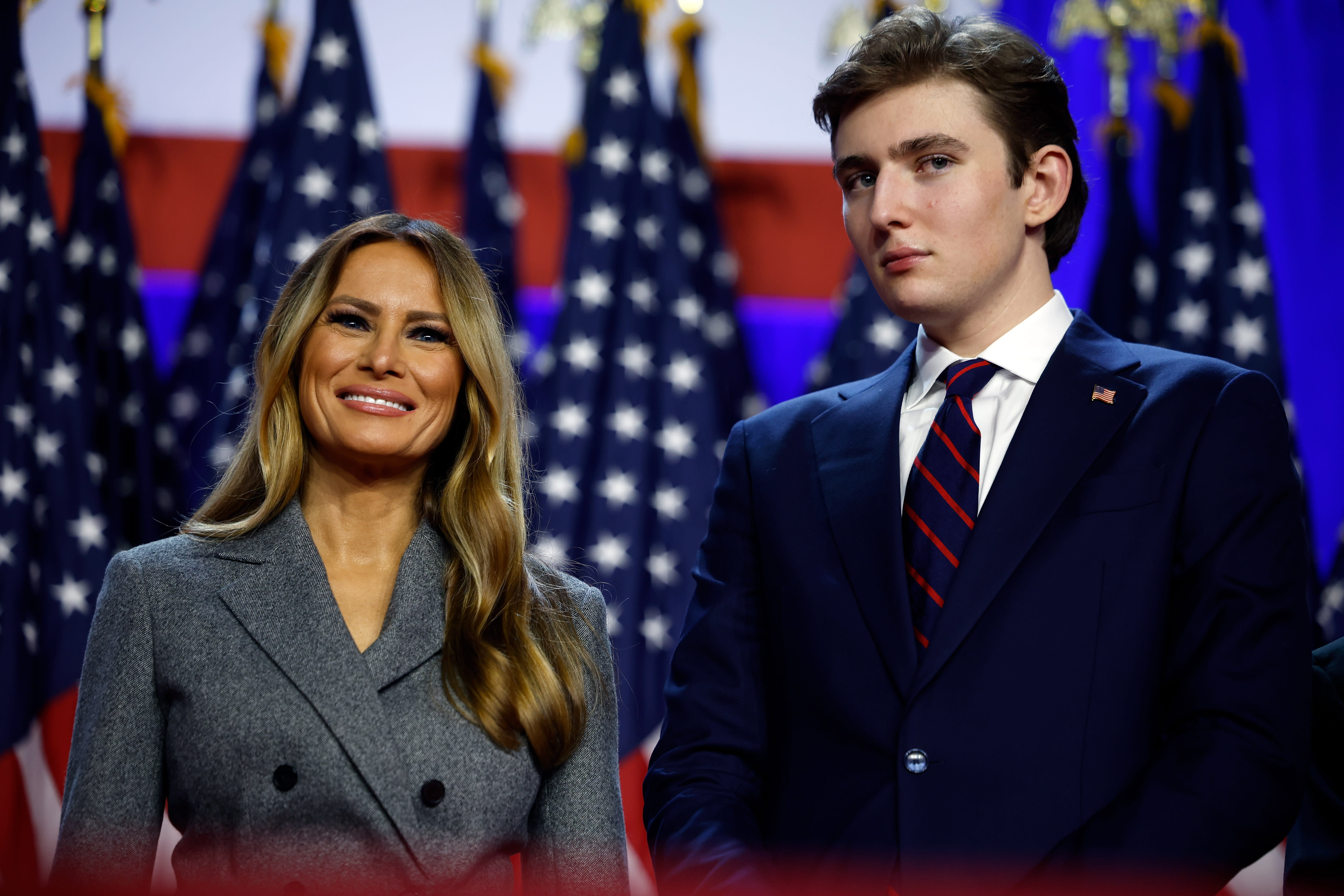 Former first lady Melania Trump and Barron Trump look on as Republican presidential nominee, former U.S. President Donald Trump speaks during an election night event at the Palm Beach Convention Center on November 06, 2024 in West Palm Beach, Florida. (photo credit:  Chip Somodevilla/Getty Images)