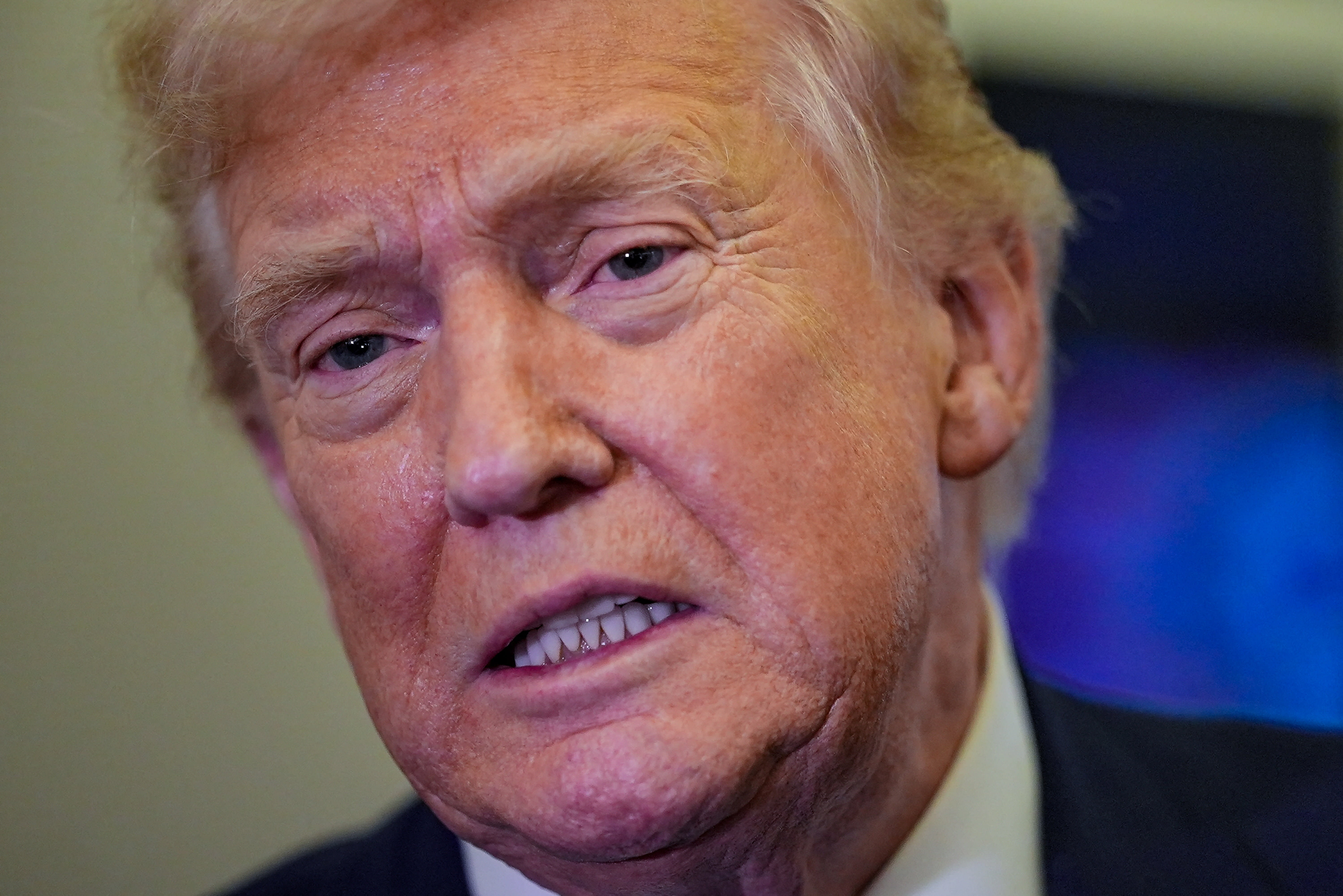 US President Donald Trump speaks with members of the media on board Air Force One en route to Palm Beach, Florida, US, February 6, 2026.  (photo credit: REUTERS/KEN CEDENO)