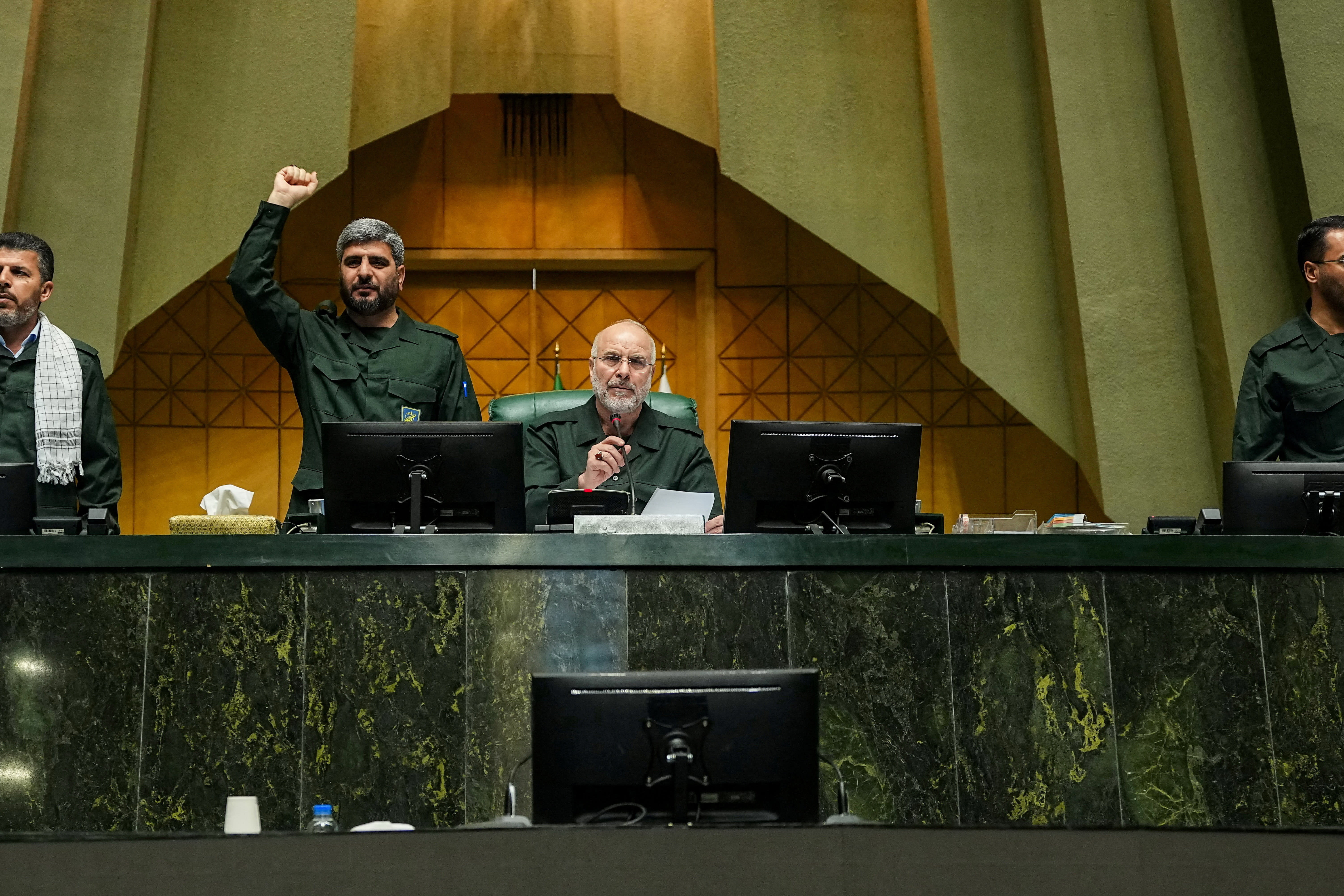 Iranian Parliament Speaker Mohammad-Bagher Ghalibaf looks on as parliament members chant in support of the IRGC while wearing military uniforms in Tehran, Iran, February 1, 2026.  (photo credit: HAMED MALEKPOUR/WANA VIA REUTERS)