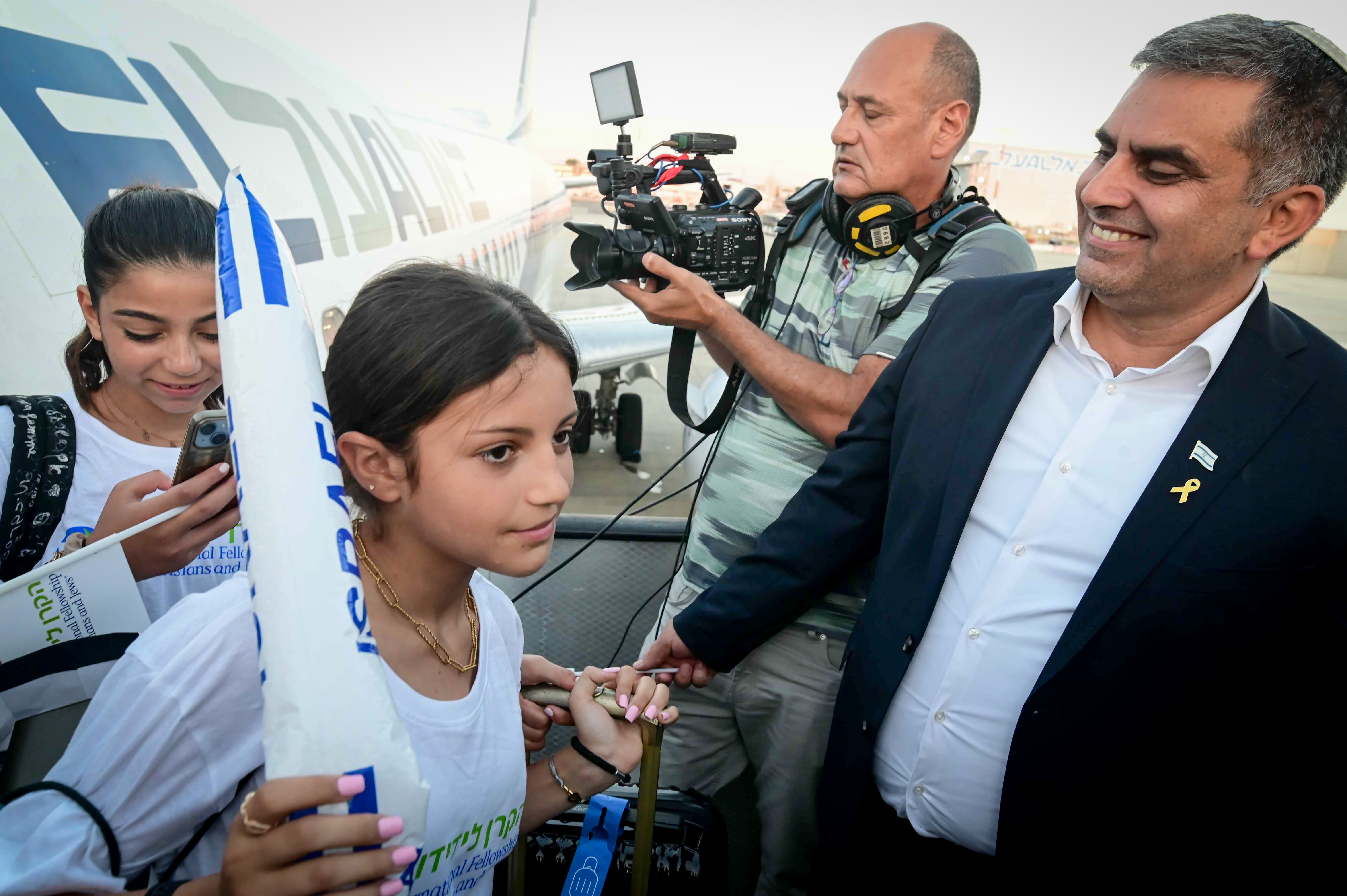 Minister of Immigration and Absorption Ofir Sofer seen with New immigrants from France arrive on a special " Aliyah Flight" at the Ben Gurion airport in central Israel on August 1, 2024. (photo credit: TOMER NEUBERG/FLASH90)