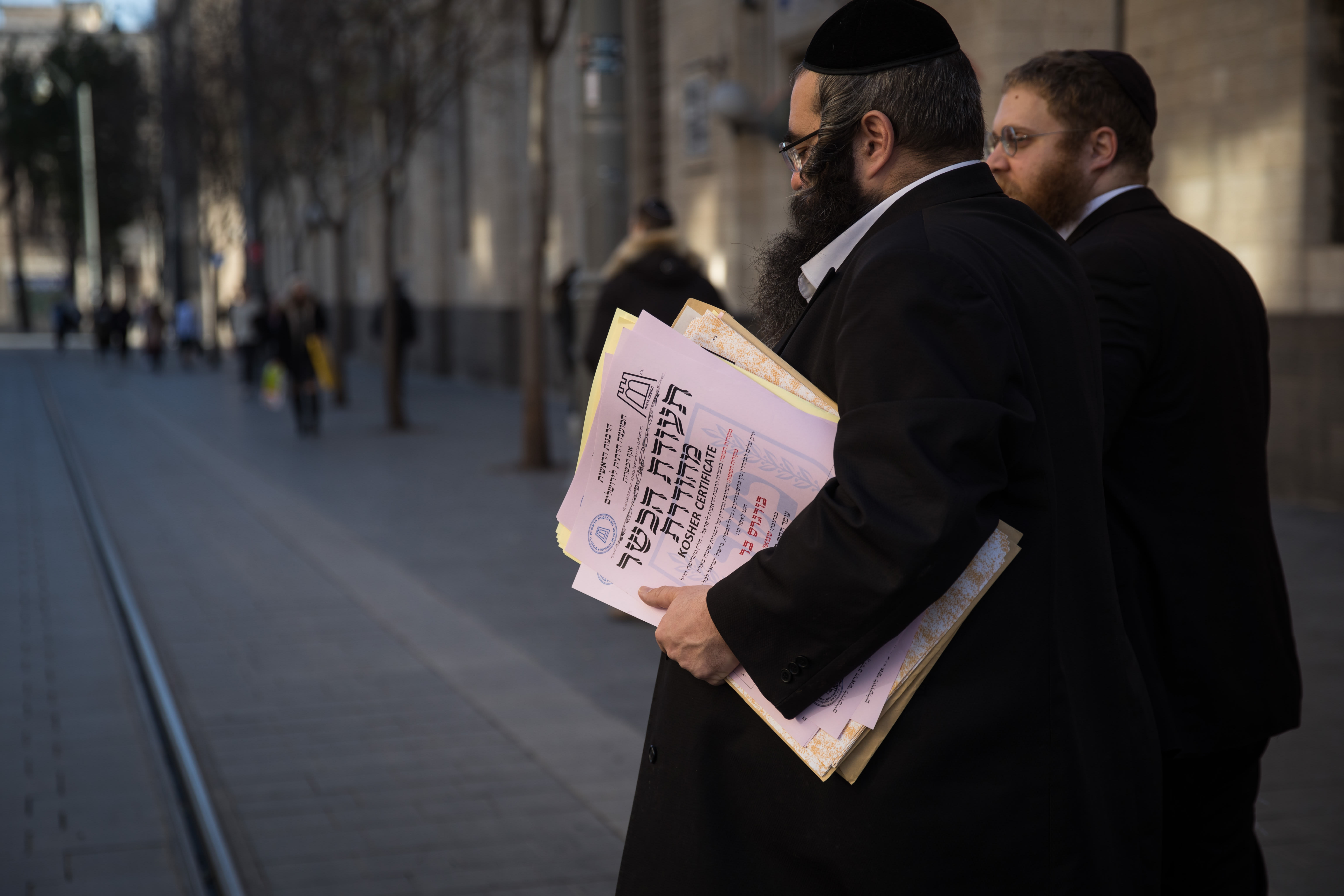 REPRESENTATIVES OF the Chief Rabbinate of Israel cross Jaffa Street in Jerusalem as they deliver a kosher certificate to a local restaurant. (photo credit: HADAS PARUSH/FLASH90)