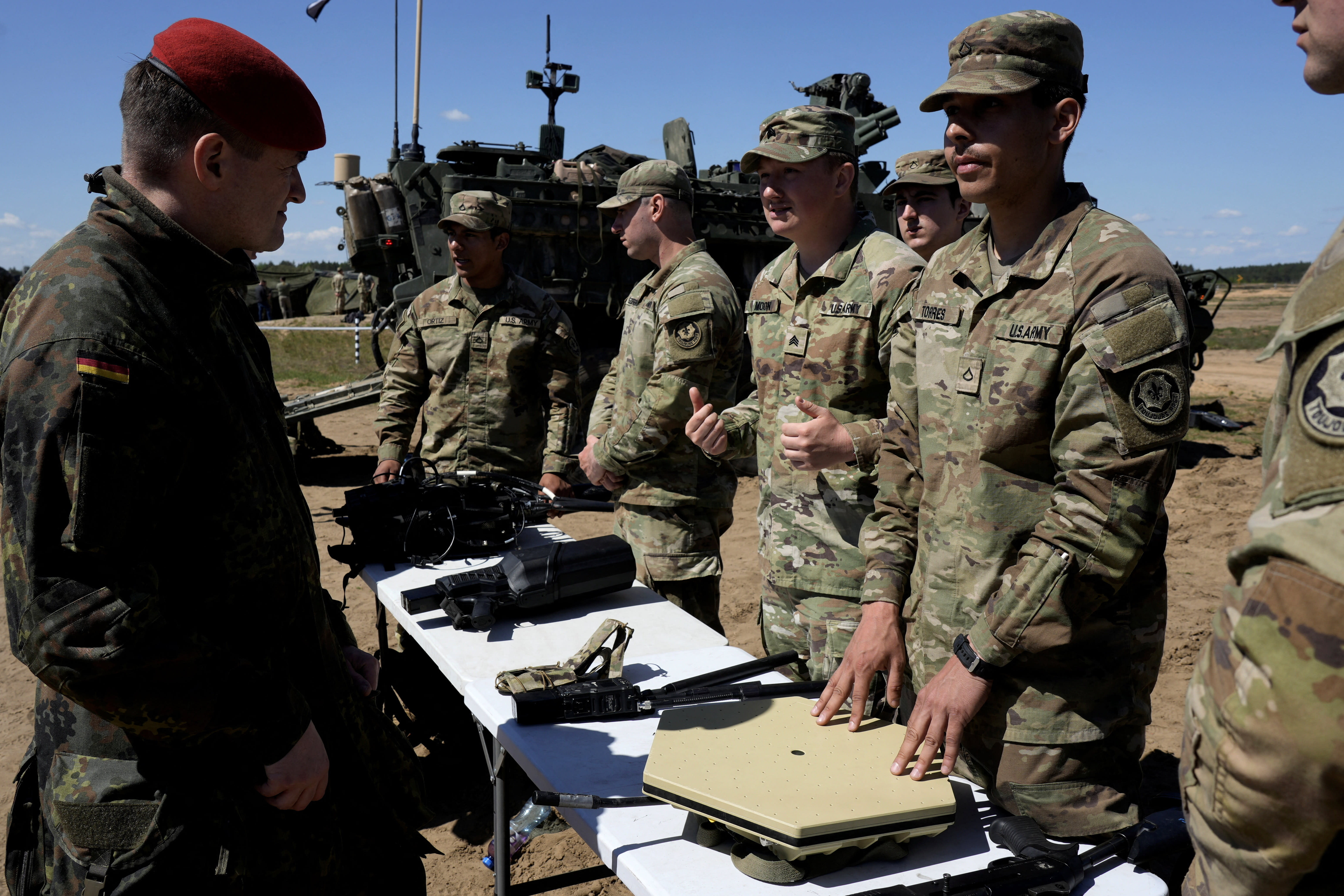A German Army serviceman talks to US Army servicemen during NATO tests of the new counter-drone technologies in Pabrade training area, Lithuania May 15, 2026. (photo credit: Ints Kalnins/Reuters)